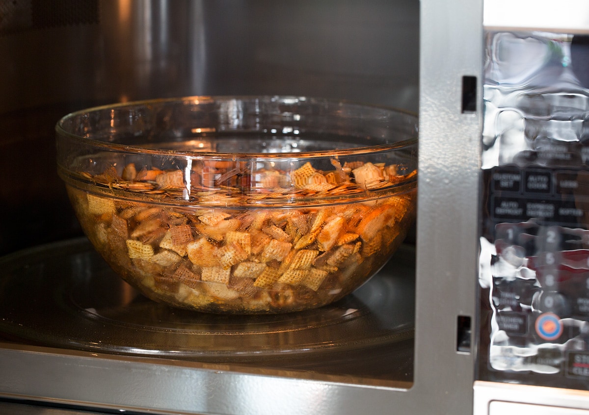 Chex Mix Chex Mix shown in a glass bowl in the microwave before cooking.