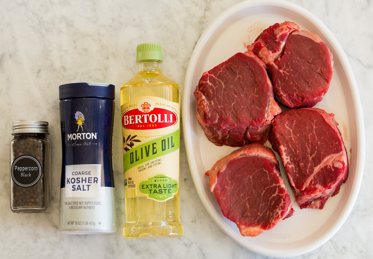 Filet Mignon Photo of ingredients for filet mignon. Includes four medium filet mignon steaks, light olive oil, kosher salt and black pepper.
