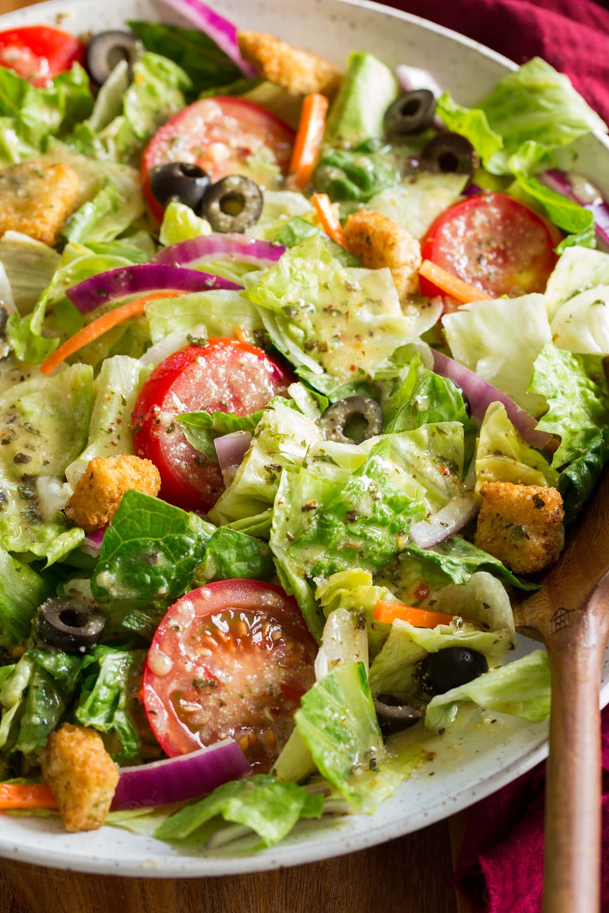 Close up photo of salad tossed with homemade Italian salad dressing.