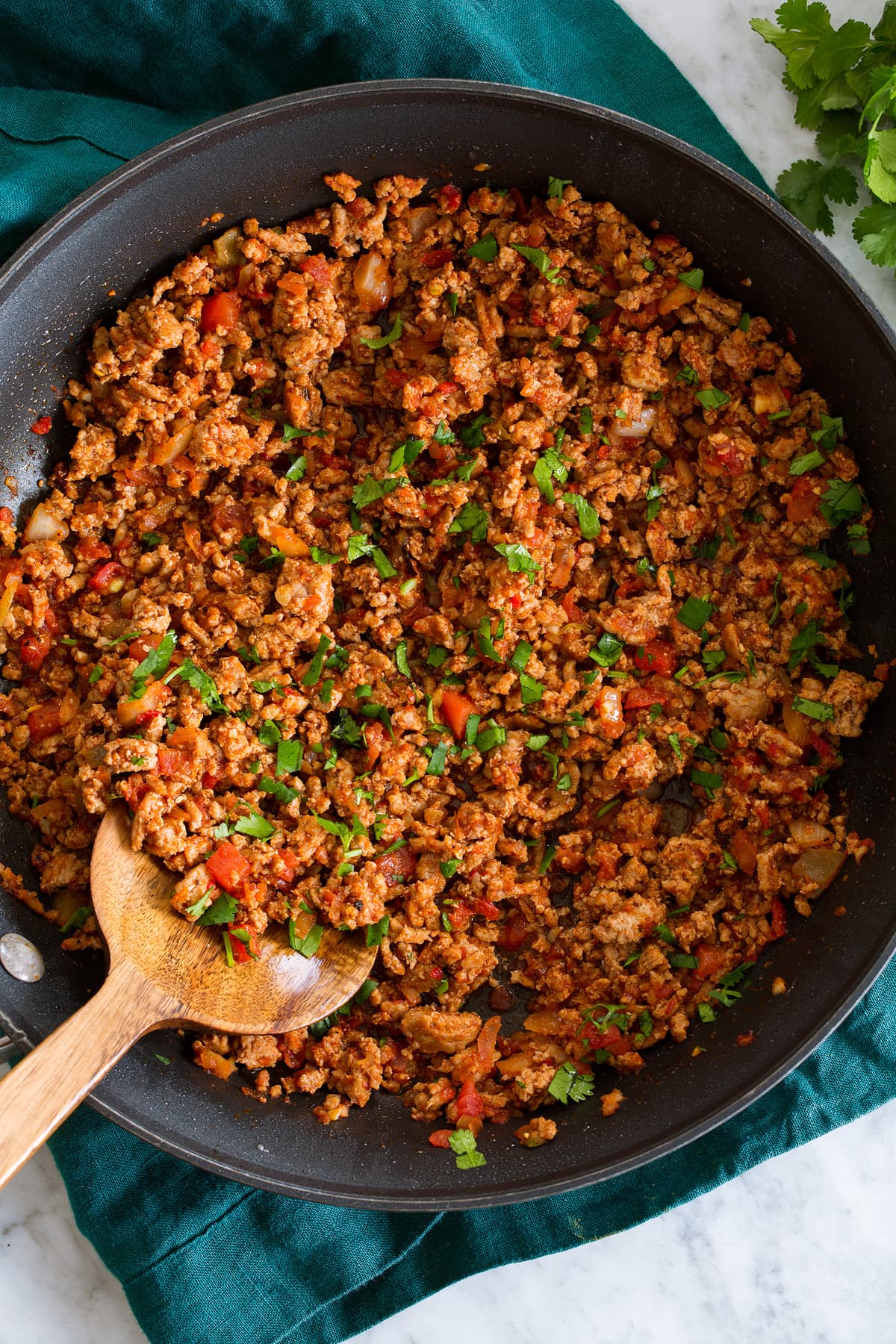Photo: Ground turkey taco meat in a large black skillet shown from above.