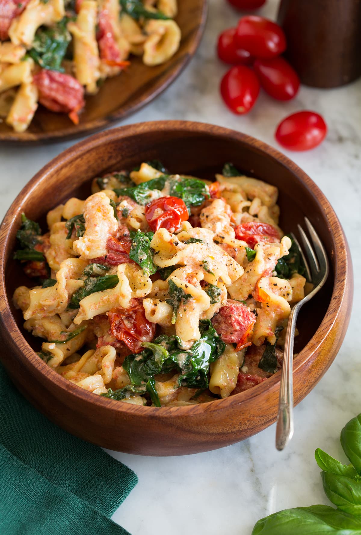 Photo: Serving of baked feta pasta shown in a wooden bowl.