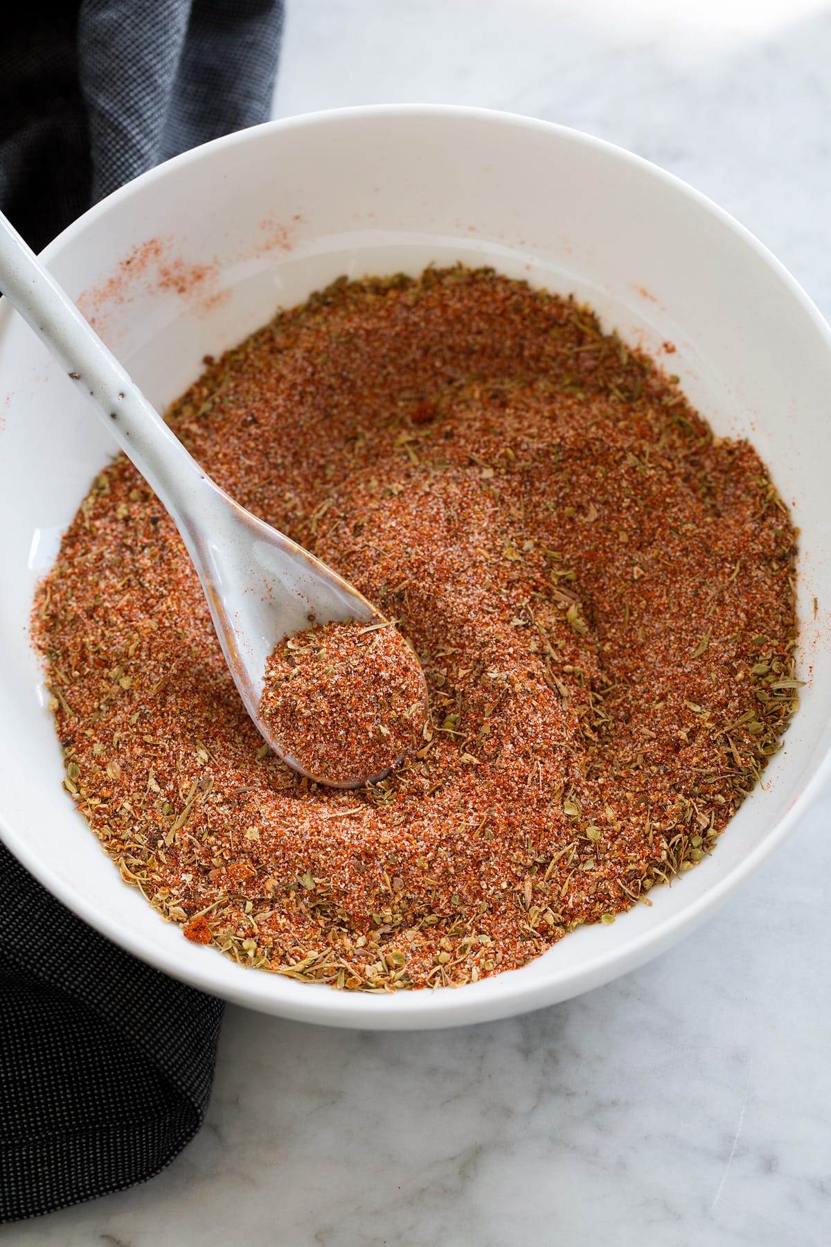 Homemade Cajun Seasoning Photo: Mixed cajun seasoning in a small bowl with a spoon.
