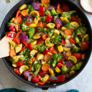 Photo: Sautéed Vegetables shown from above in a black skillet sitting on a marble tabletop.