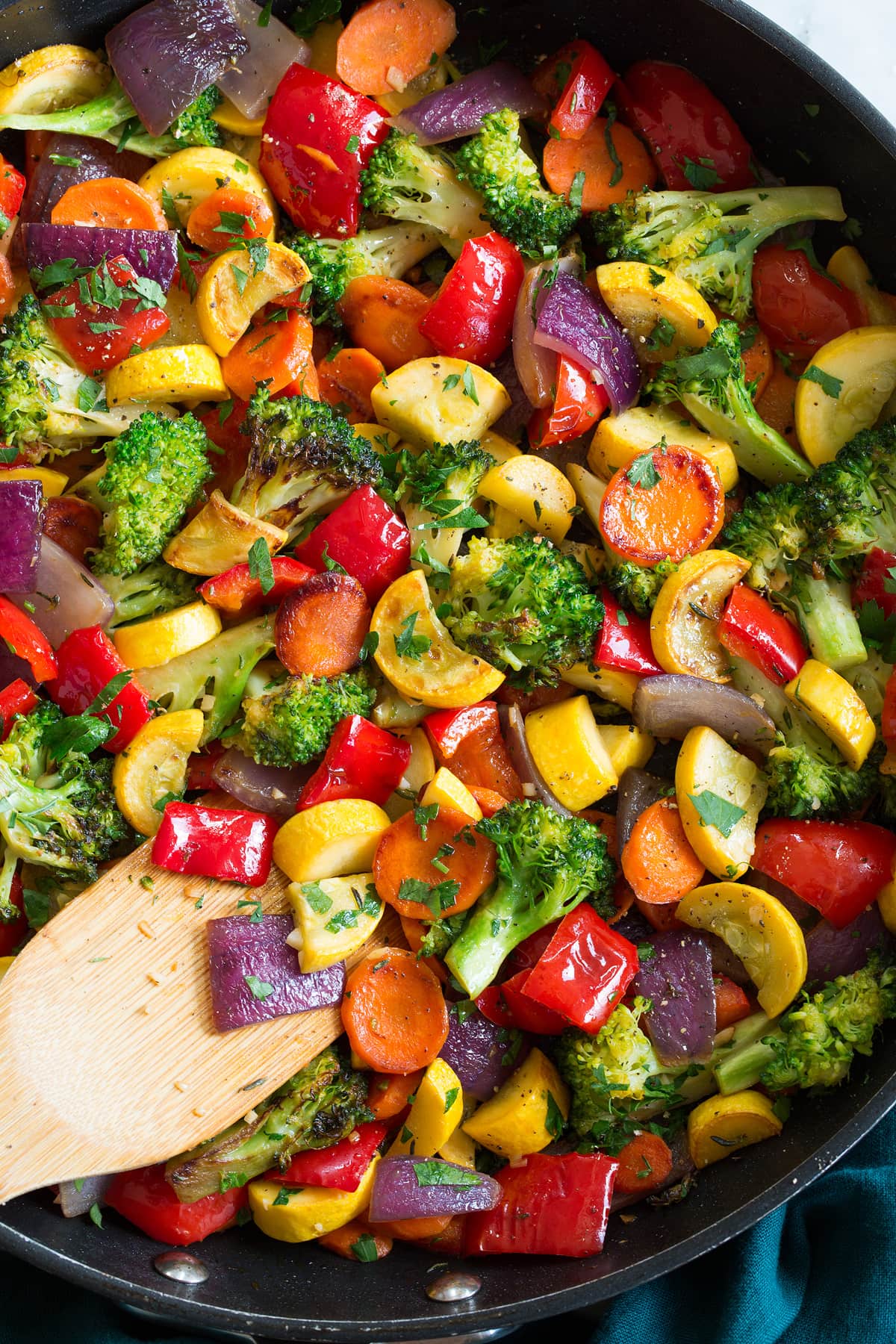 Close up photo of chopped sauteed vegetables in a pan.