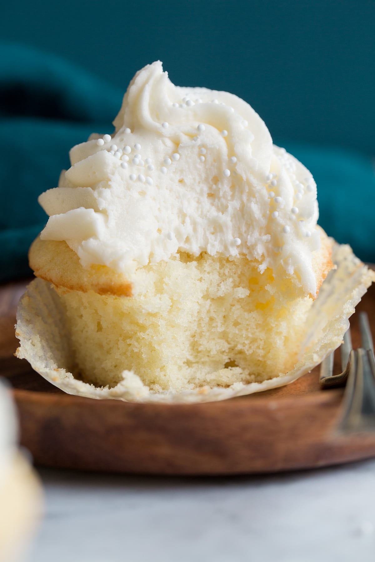 Close up photo of a single cupcake that has been bitten into.