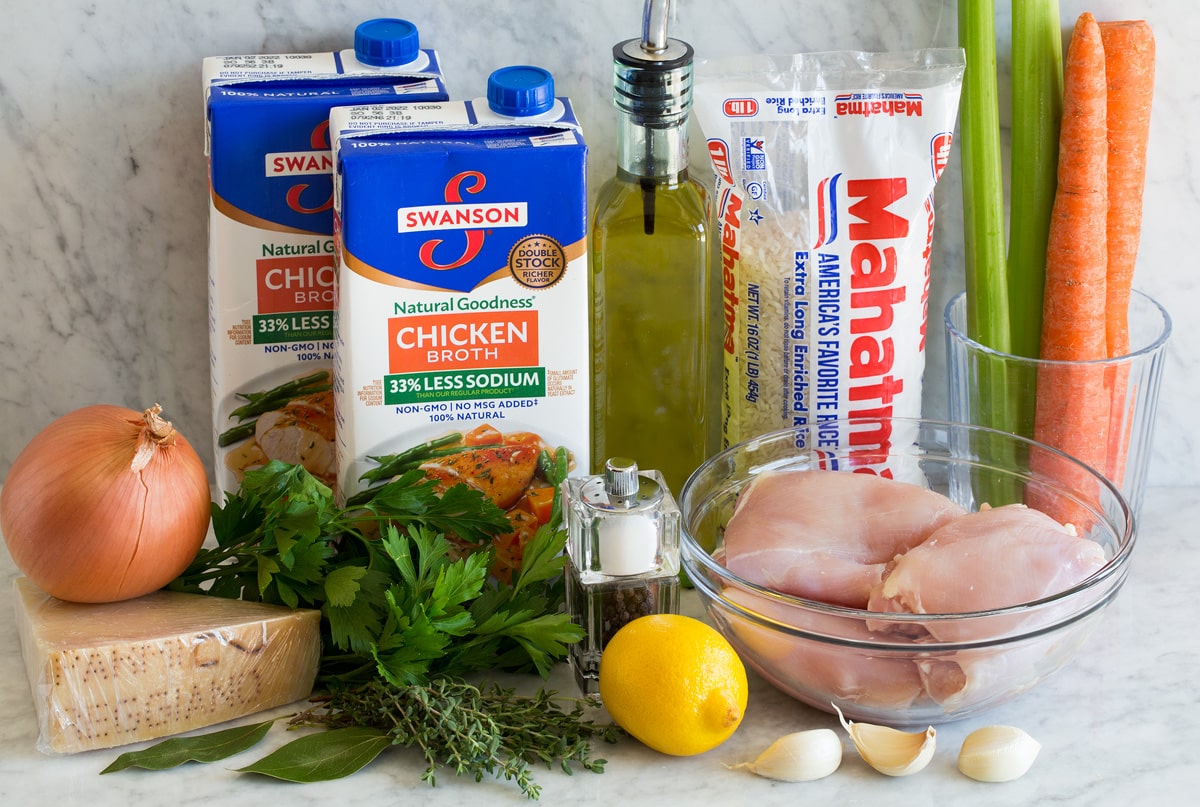 Photo of ingredients used to make chicken and rice soup shown on a countertop.