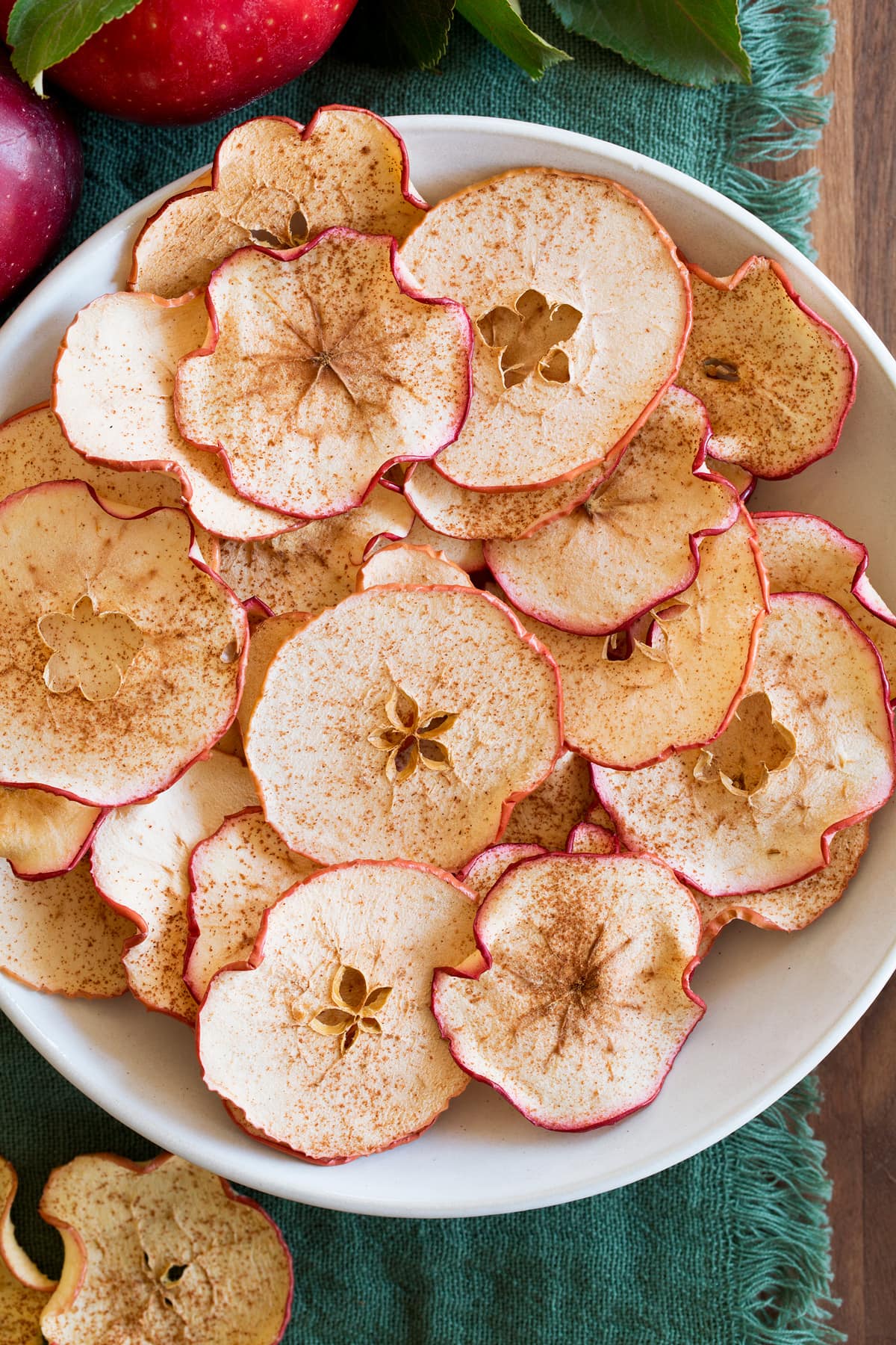 Baked Apple Chips Overhead view of homemade baked apple chips in a white bowl.