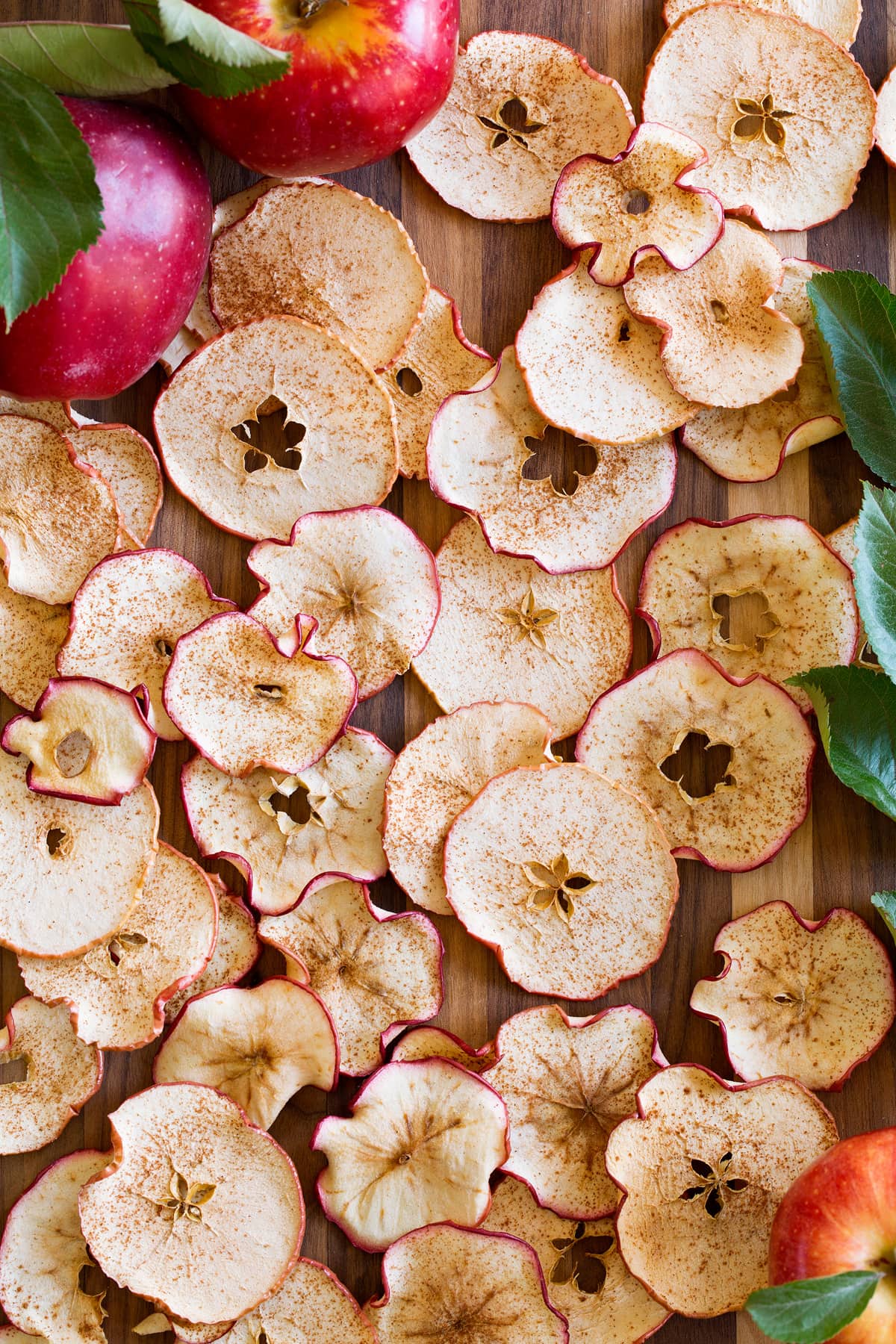 Baked Apple Chips Apple chips spread out on a wooden surface.