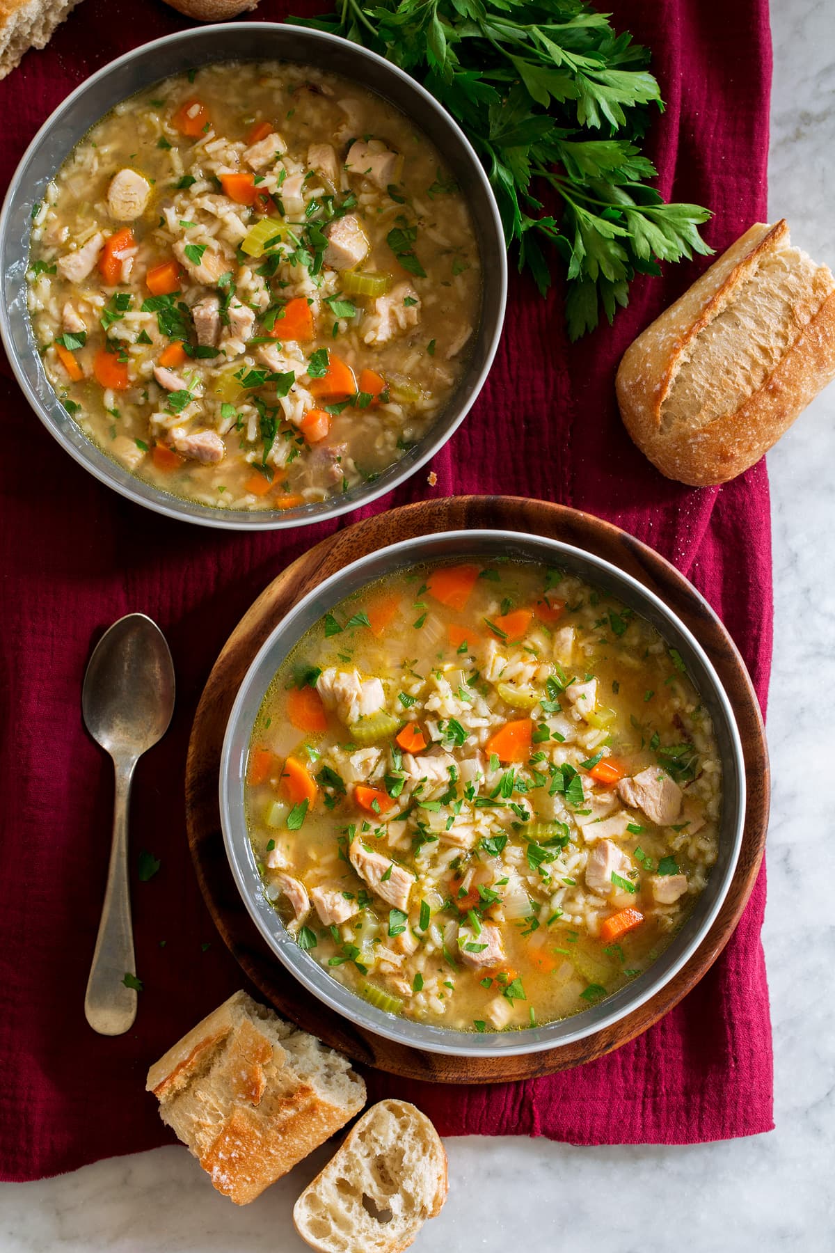 Two bowls filled with chicken rice soup.