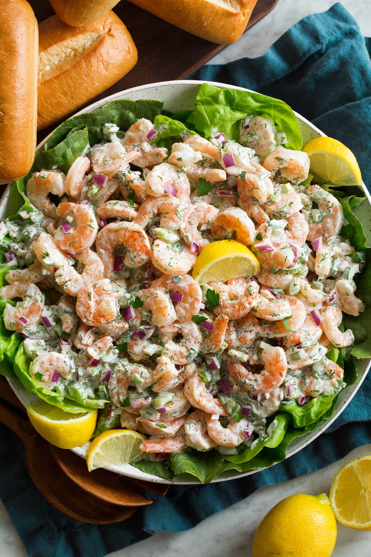 Shrimp Salad Shrimp salad with lemons and lettuce in a serving bowl.