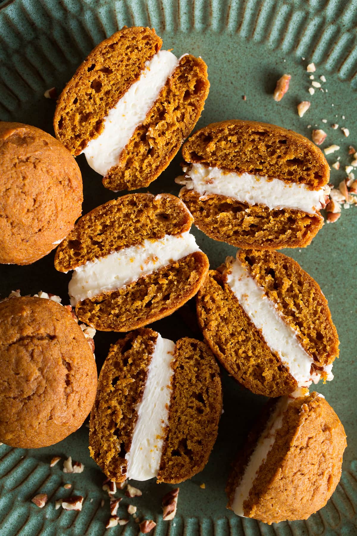 Pumpkin Whoopie Pies Pumpkin whoopie pies cut in half to show texture and frosting filling.