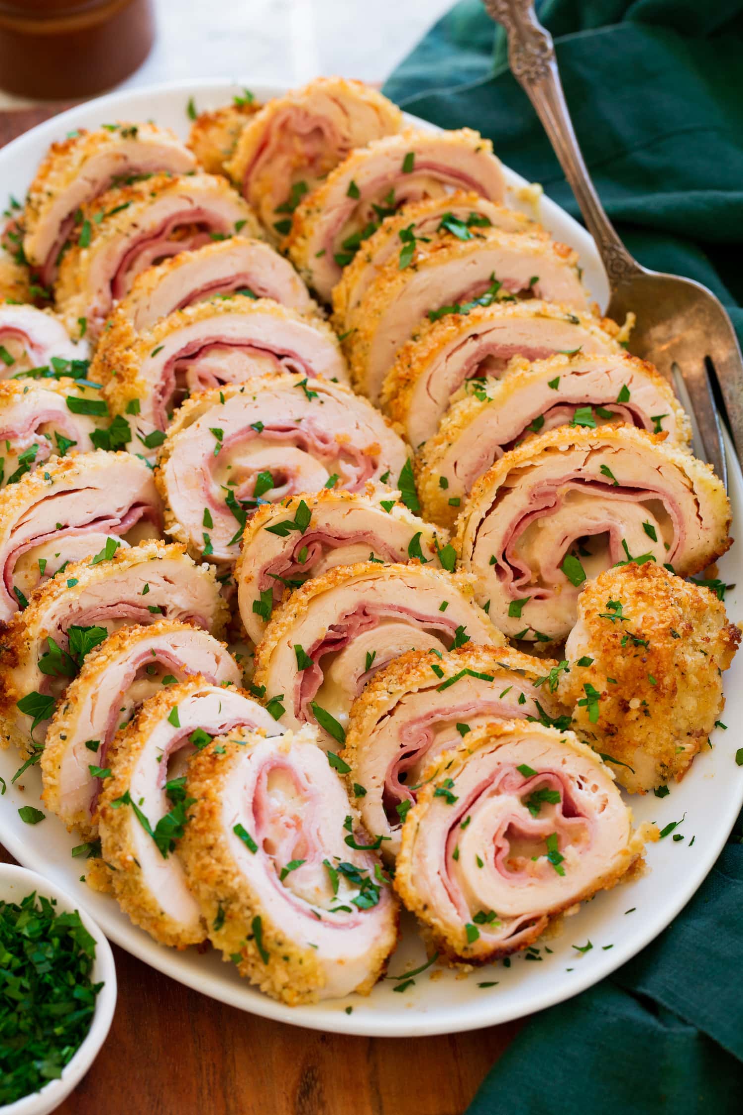 Chicken Cordon Bleu shown sliced on a white serving platter.