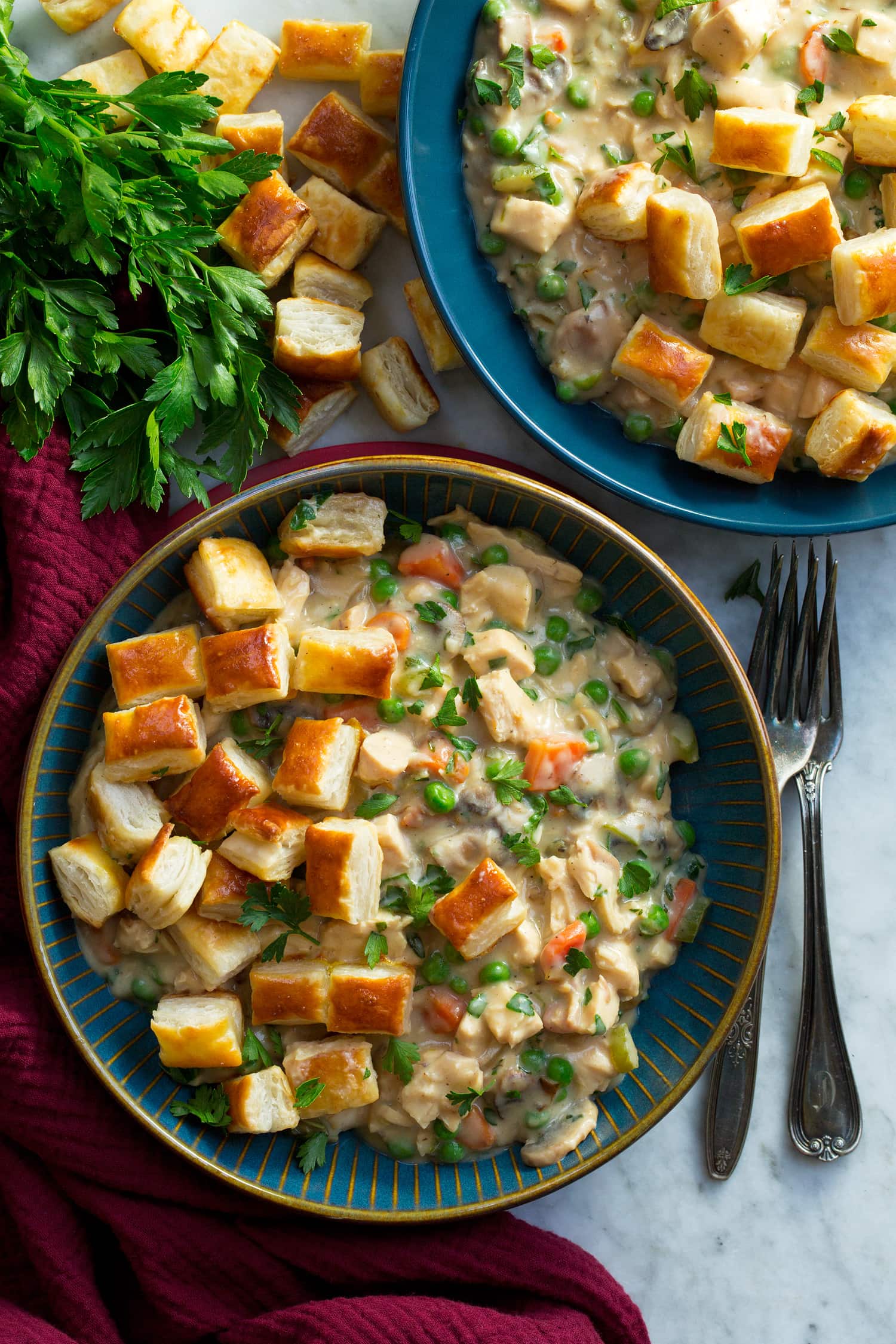 Chicken Pot Pie with Puff Pastry Overhead photo of chicken pot pie servings in bowls with puff pastry pieces.