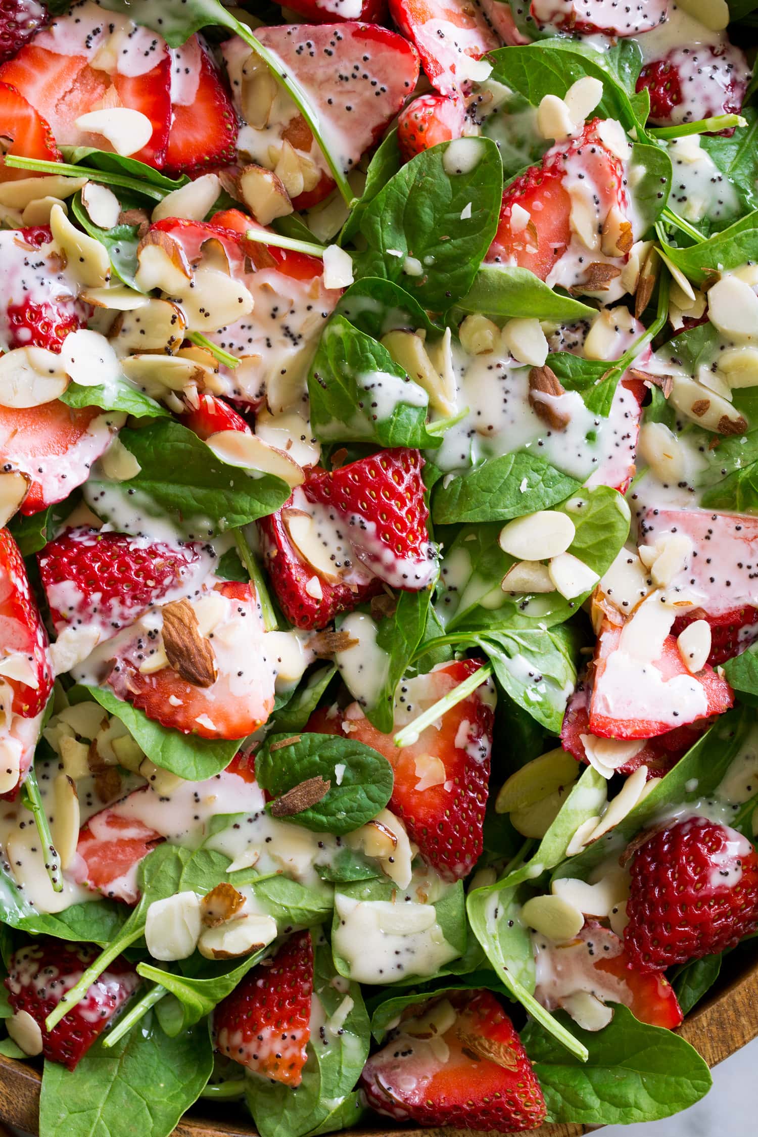 Strawberry Spinach Salad with Poppy Seed Dressing Close up photo of strawberry spinach salad with almonds.