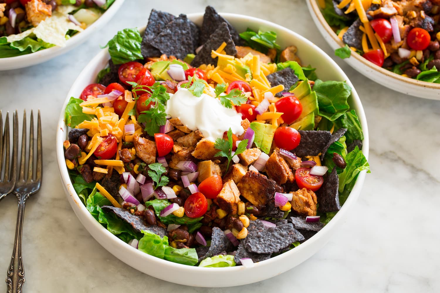Chicken Taco Salad Layered taco salad with all prepared ingredients.