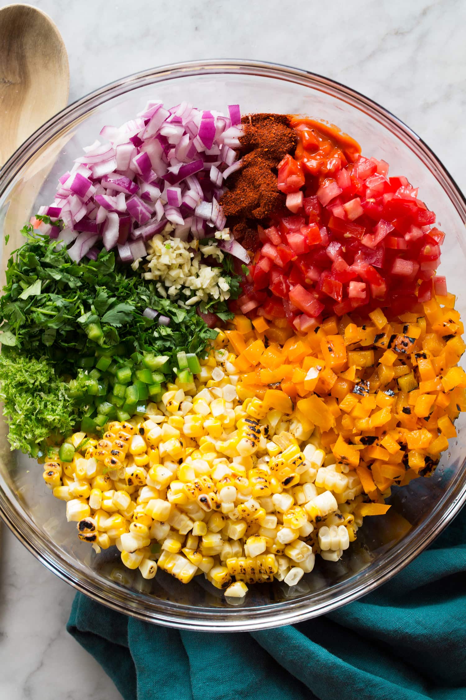 Corn Salsa Rainbow of corn salsa ingredients chopped in a mixing bowl before tossing.