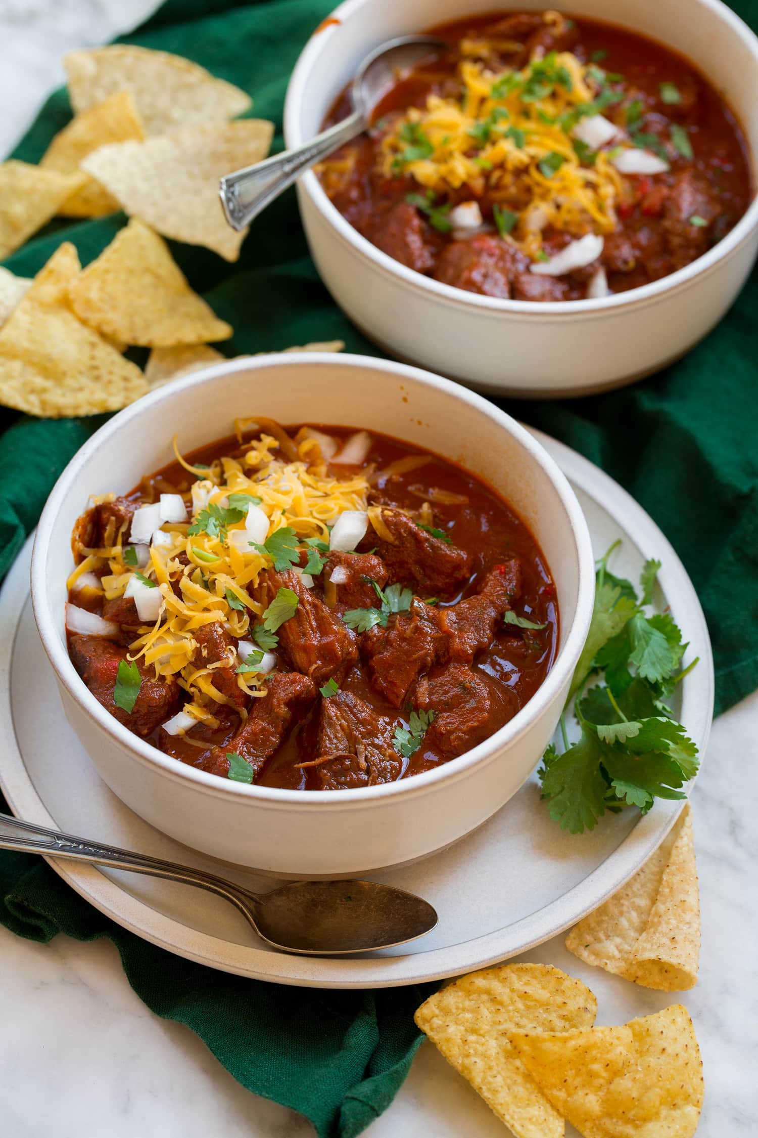 Chili con Carne Two servings of homemade chili con carne with chuck roast and dried peppers.