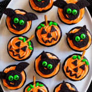 Halloween cupcakes decorated as pumpkins, bats and cats.