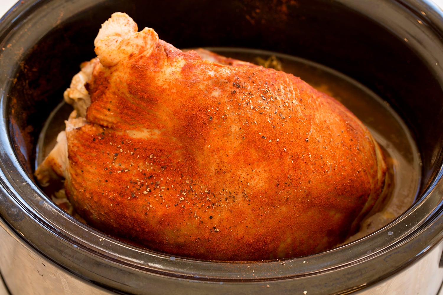Finished seasoned turkey breast in crockpot. Finished seasoned turkey breast in crockpot.