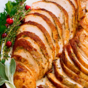 Close up photo of cooked crockpot turkey breast with herbs.