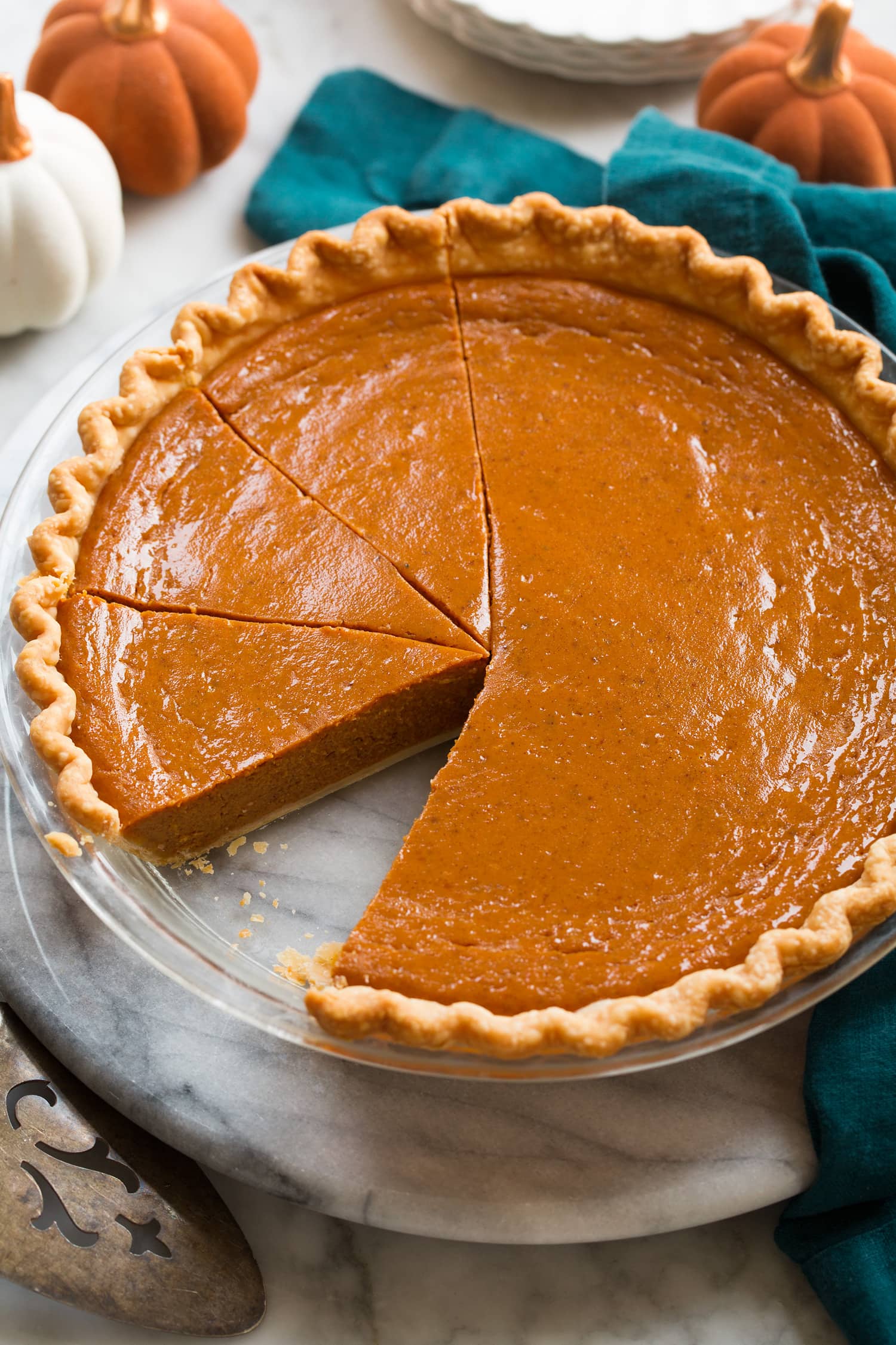 Side angle of pumpkin pie in pan.