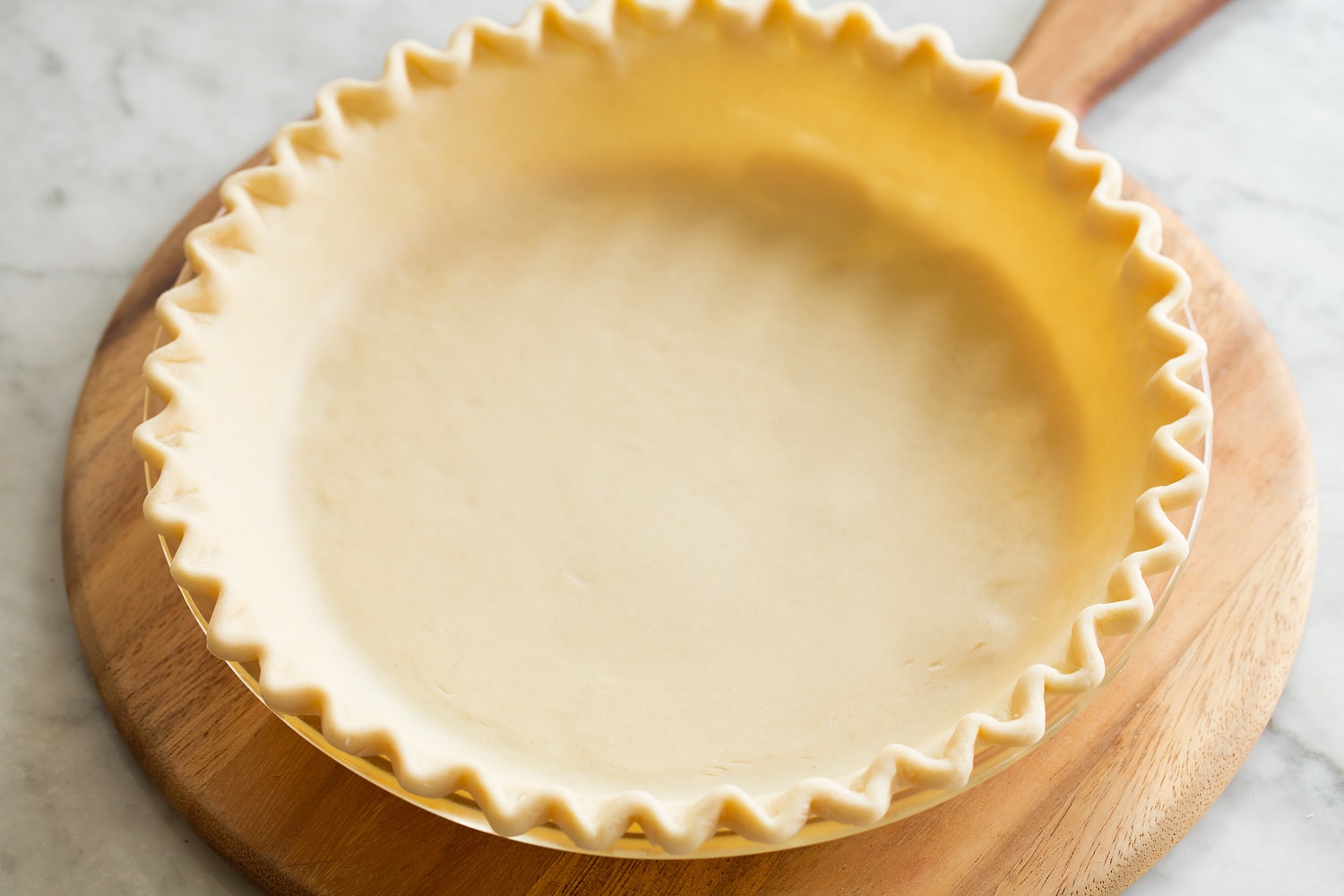 Decorating pie crust in pie dish.