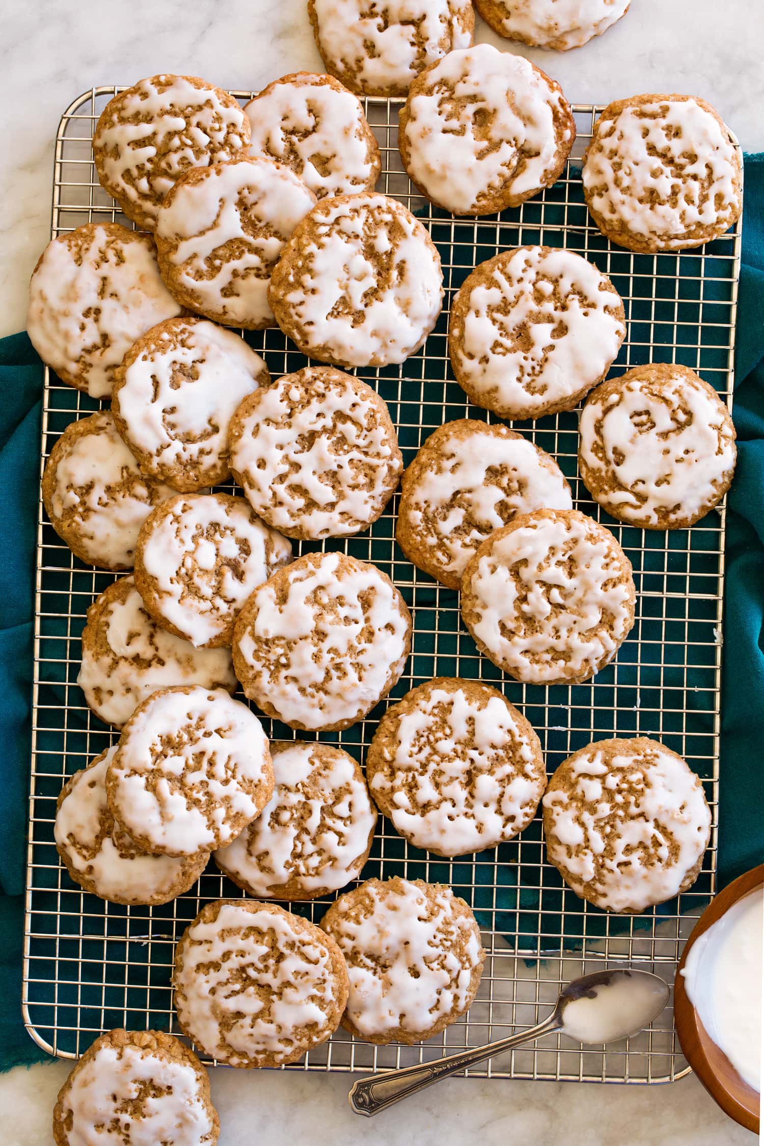Iced oatmeal cookies on a wire rack.