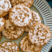 Oatmeal cookies with vanilla icing on a turquoise plate.