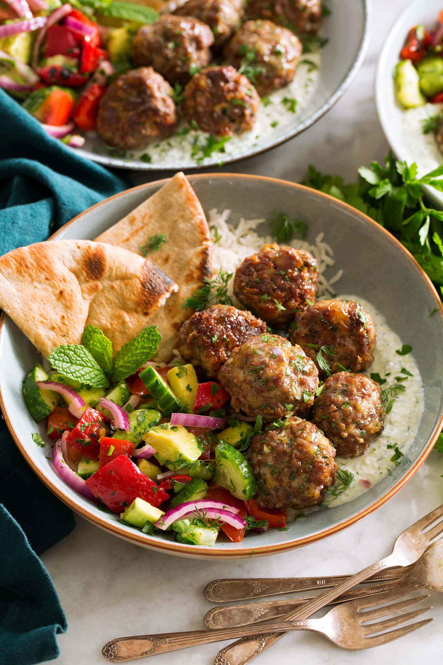 Greek Meatballs (Keftedes) Greek meatballs shown served with tzatziki and greek salad.