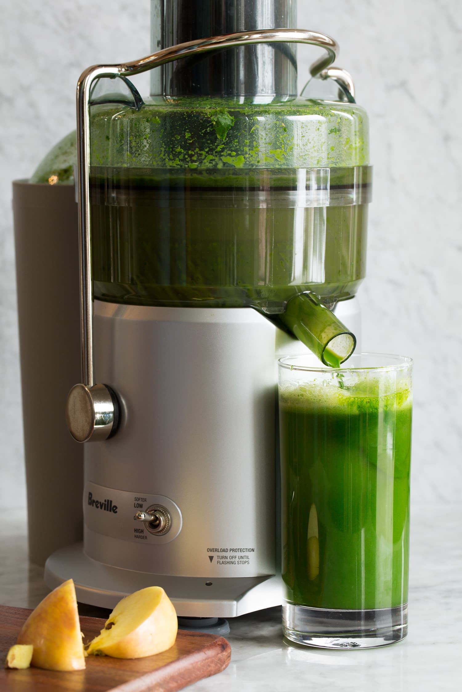 Green Juice An electric juicer making green juice.