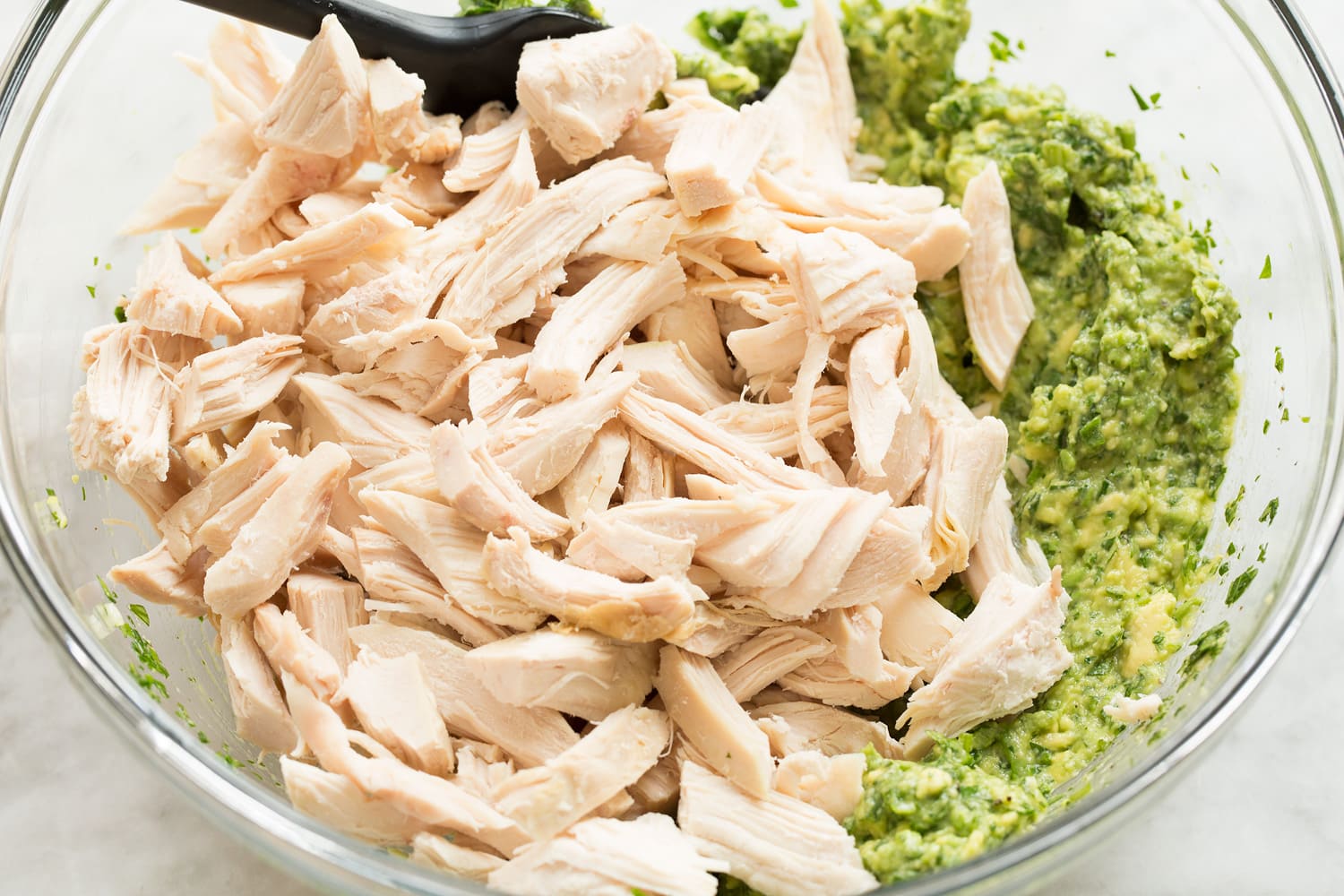 Avocado Chicken Salad Adding chicken to avocado mixture.