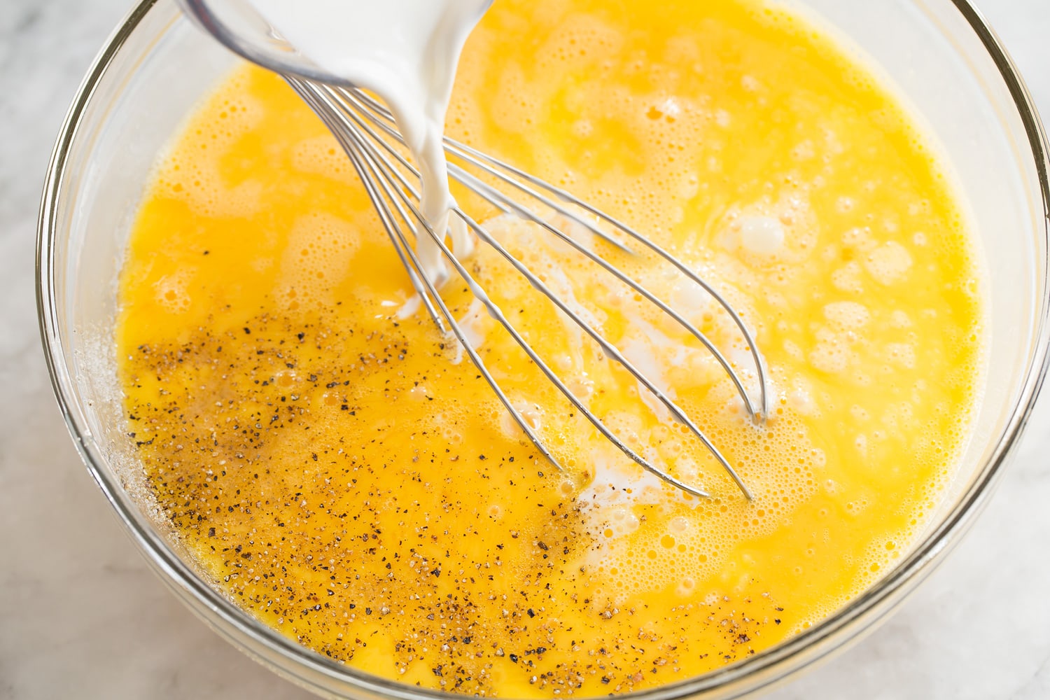 Sheet Pan Eggs Whisked egg and half and half mixture.