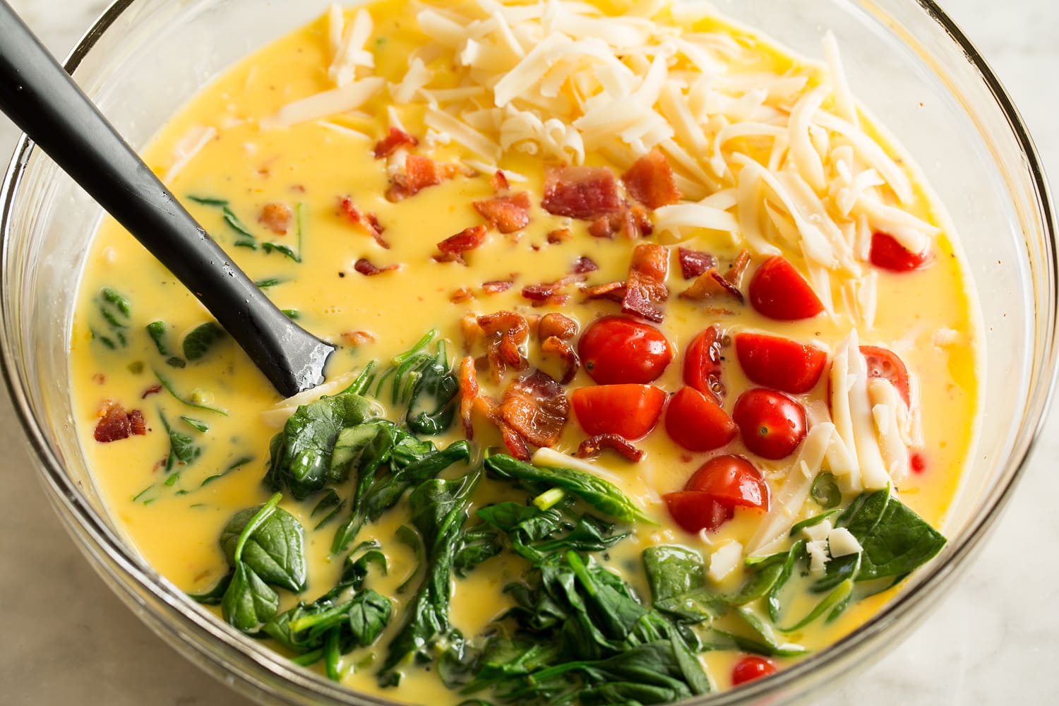 Sheet Pan Eggs Mix ins added to eggs.