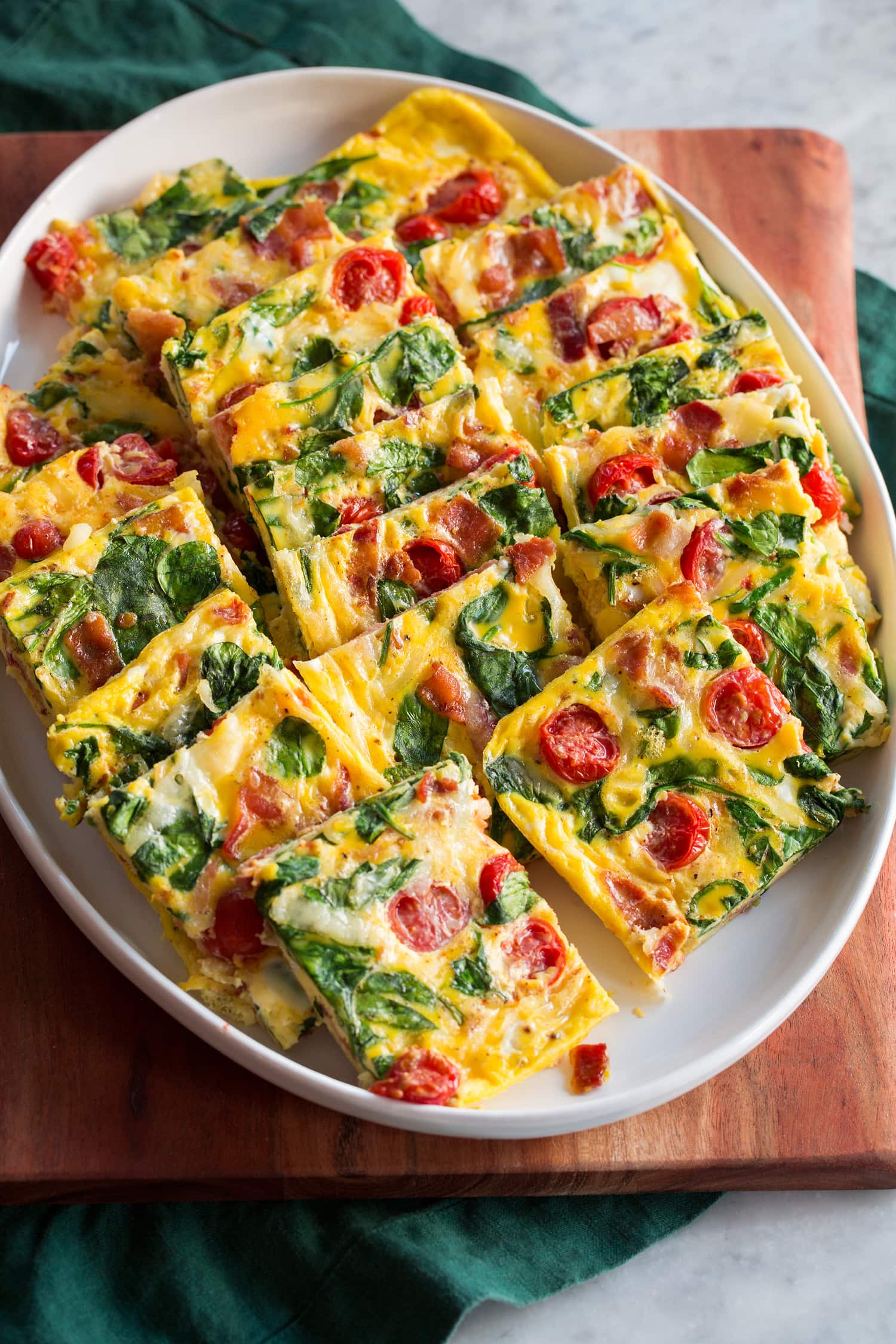 Sheet Pan Eggs Baked eggs with tomatoes, spinach, swiss, and bacon.