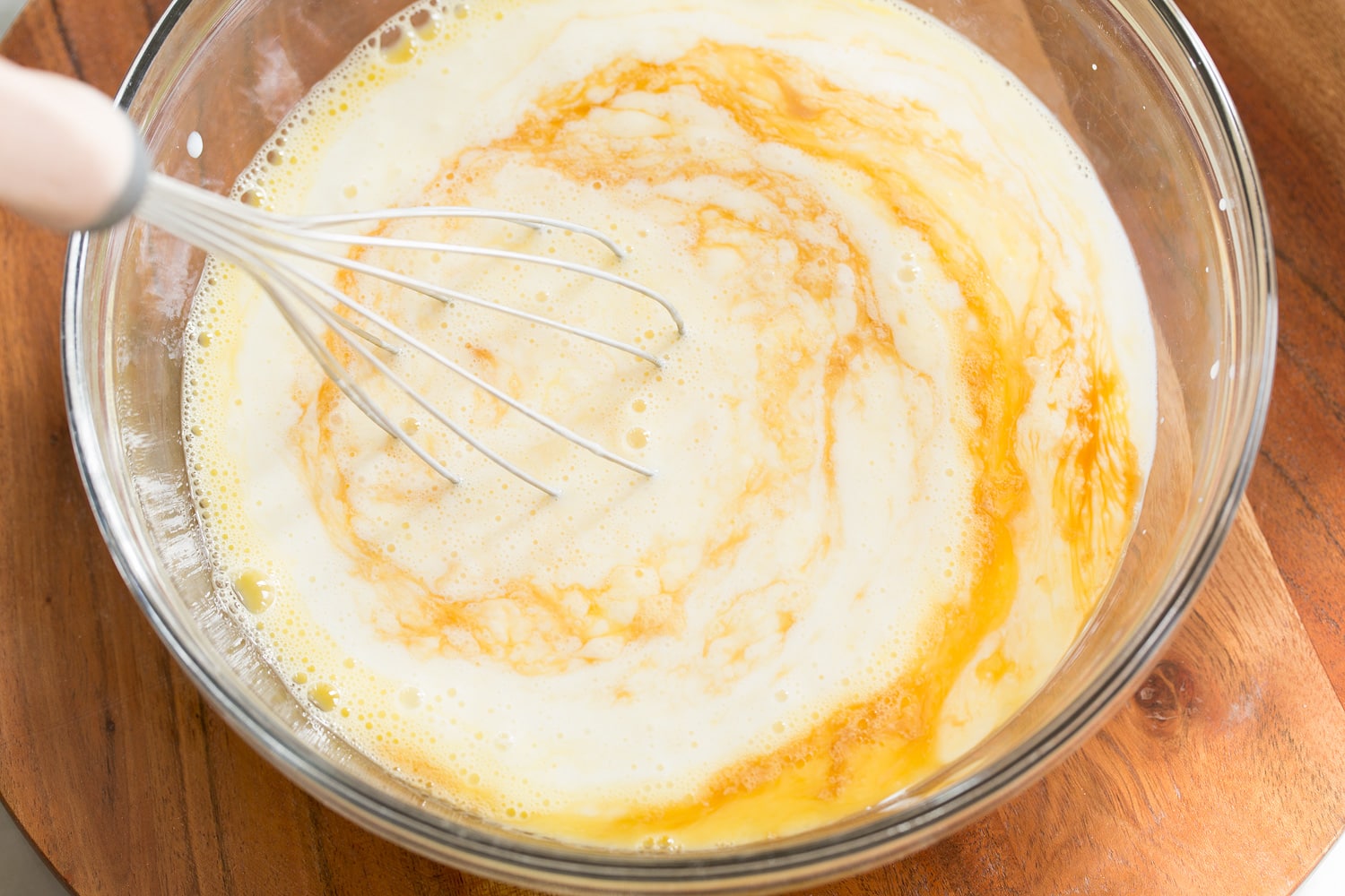 Sheet Pan Pancakes Adding buttermilk to pancakes mixture.