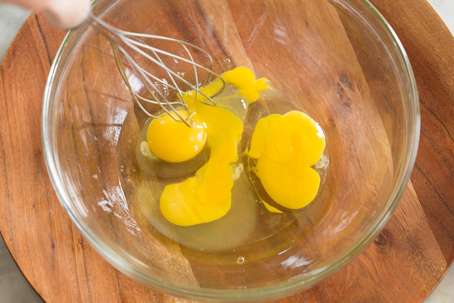 Sheet Pan Pancakes Whisking eggs in mixing bowl.