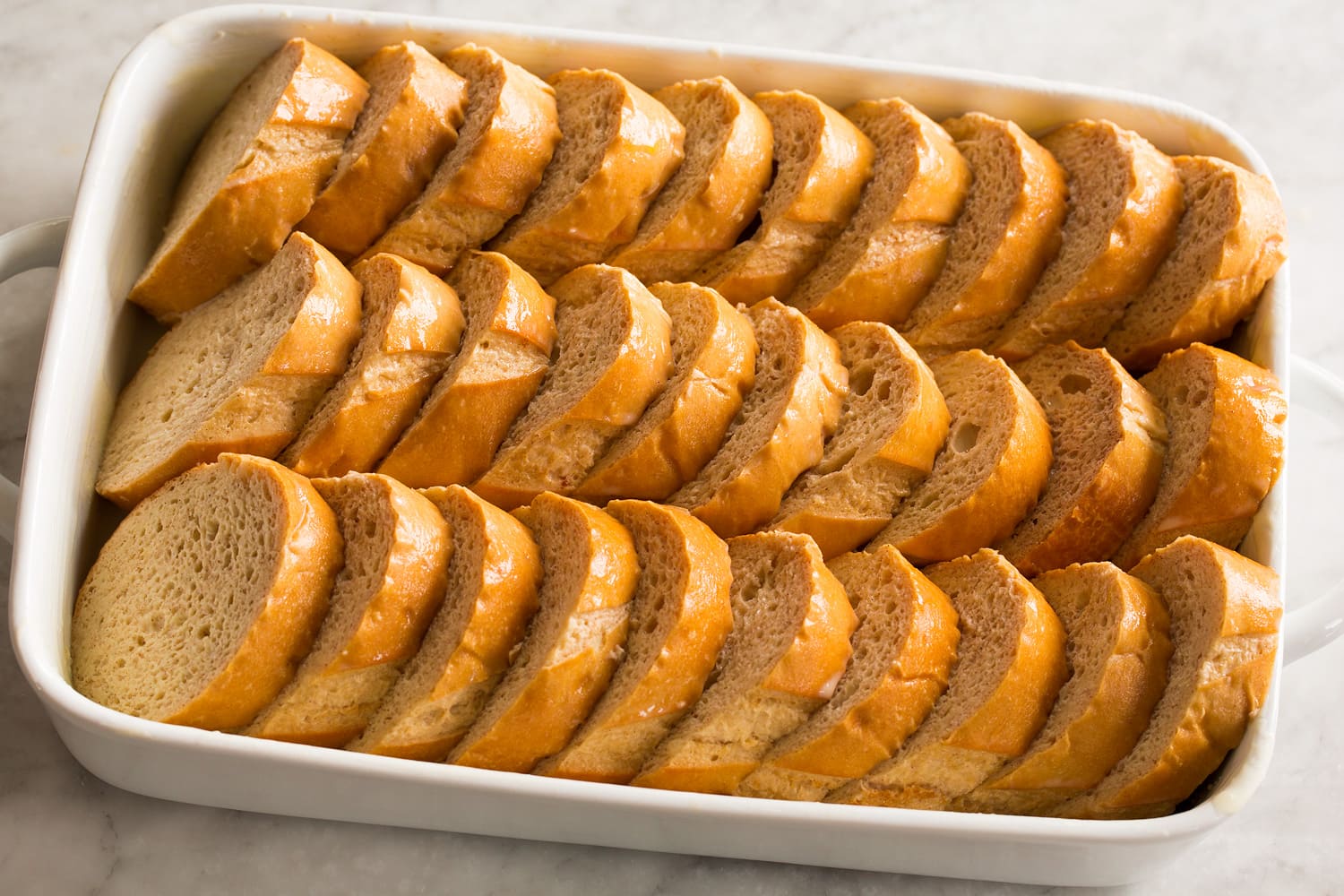 Baked French Toast French toast aligned in baking dish.