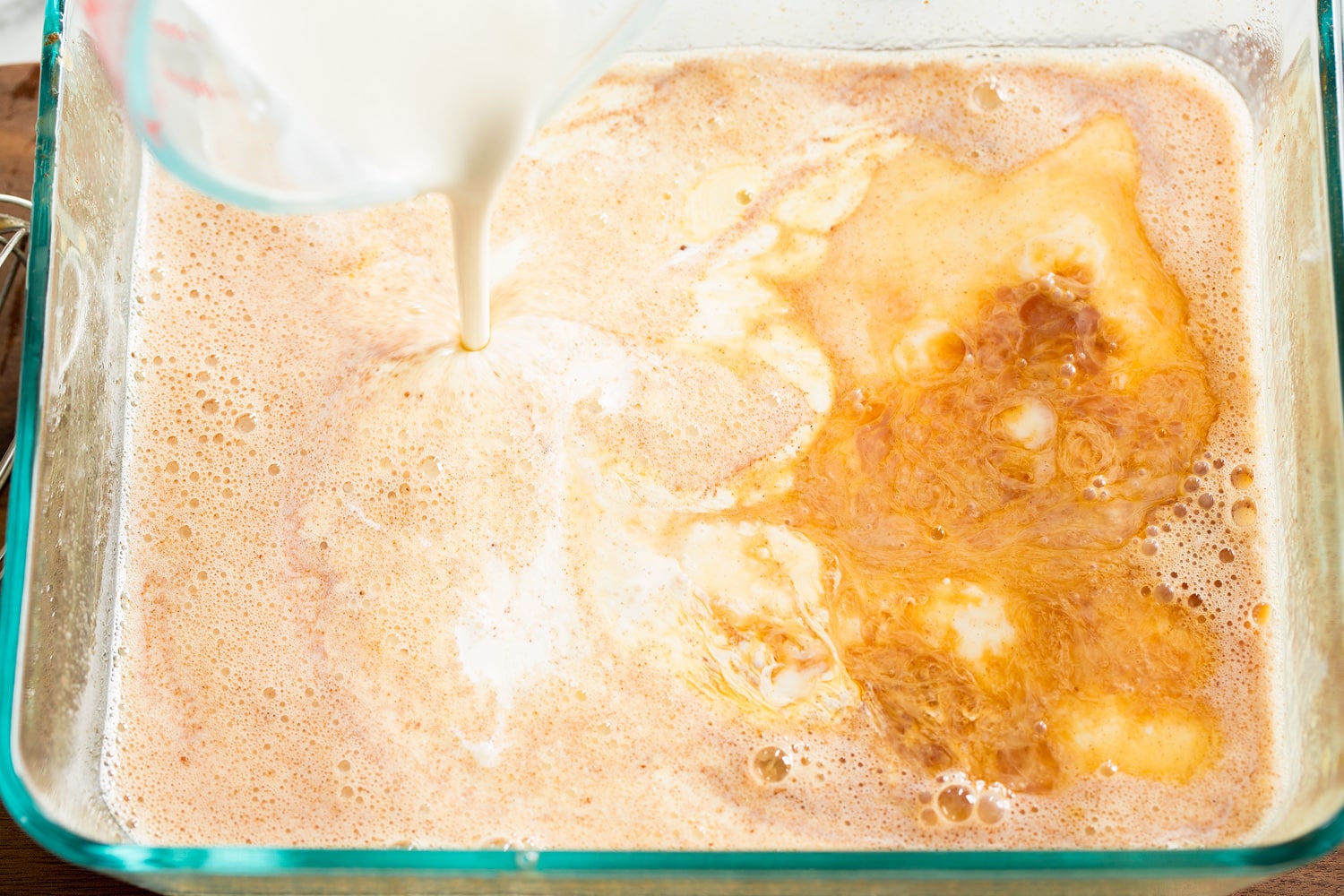 Baked French Toast Adding milk and cream to french toast custard mixture.