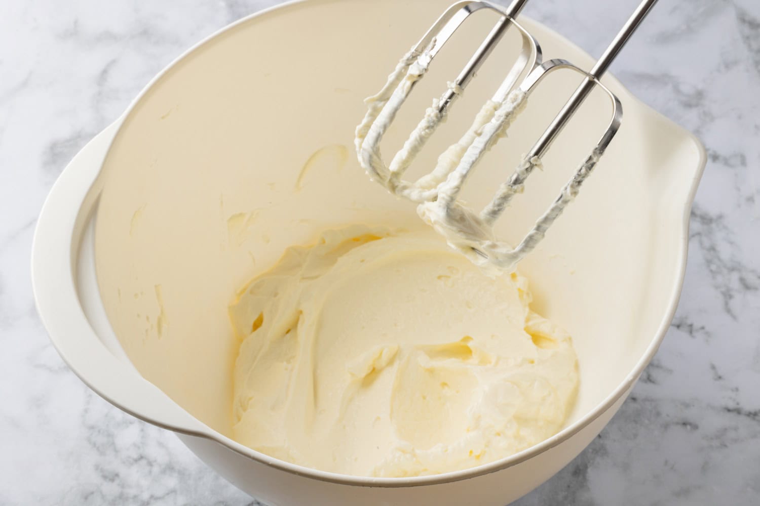 Lemon Icebox Pie Cream cheese whipped in a mixing bowl.