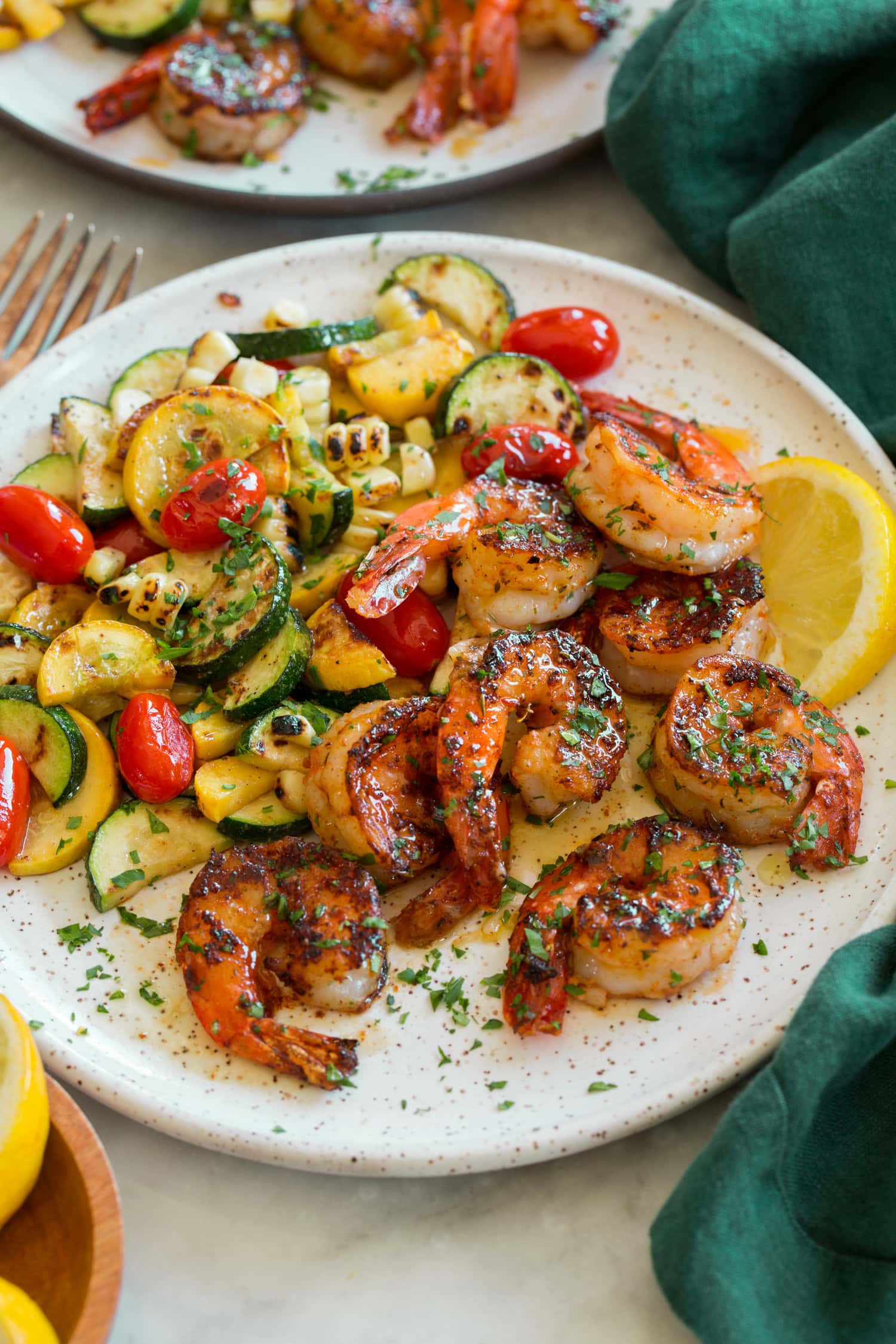 Blackened Shrimp Shrimp with serving suggestion of zucchini, squash, corn and tomatoes.