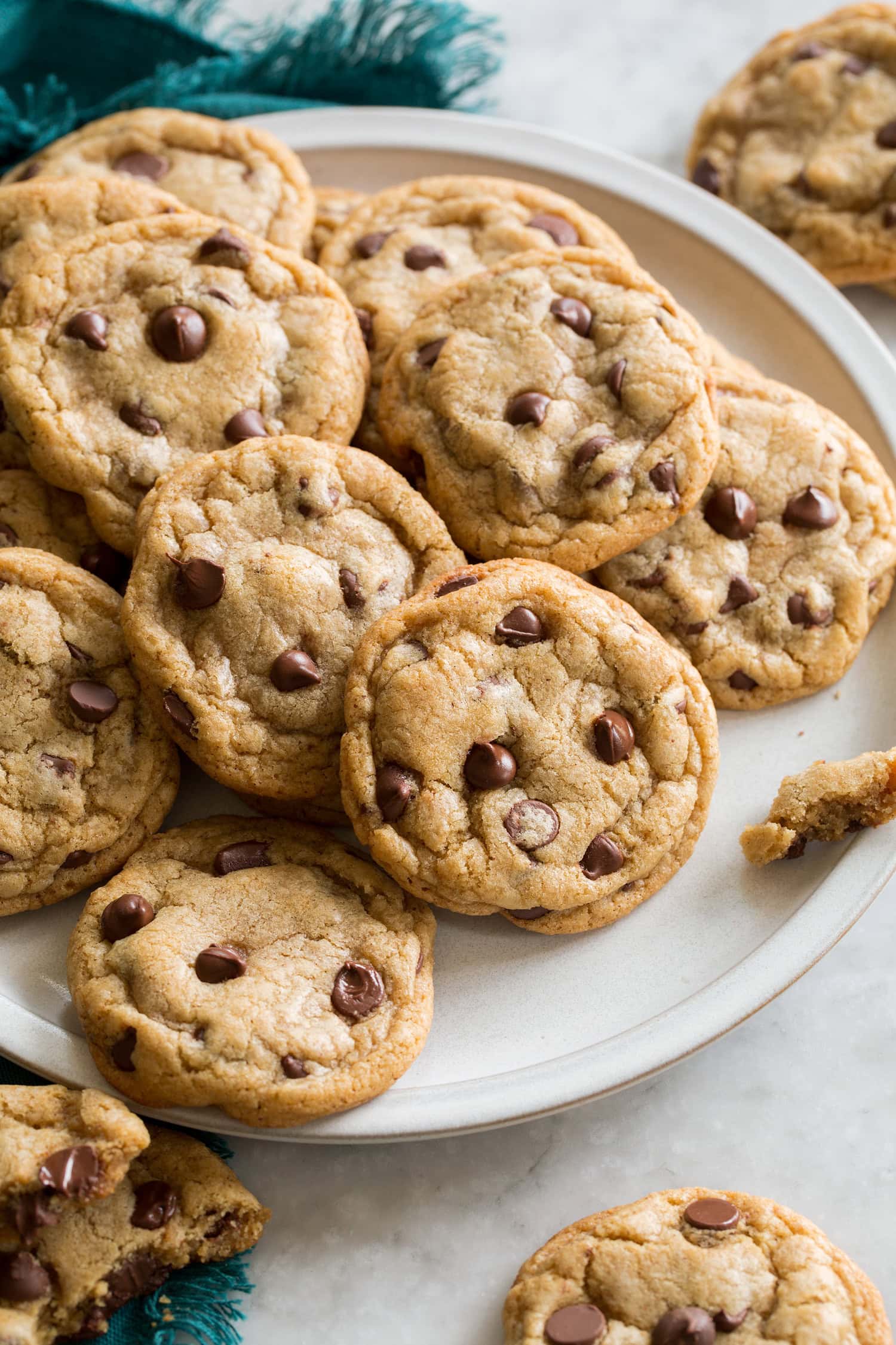 Plate full of browned butter chocolate chip cookies overlapping.