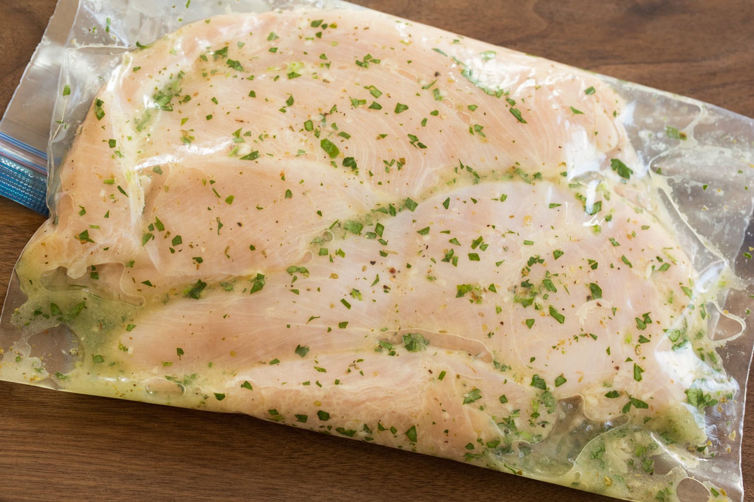 Grilled Chicken Salad Chicken breasts soaking in marinade.