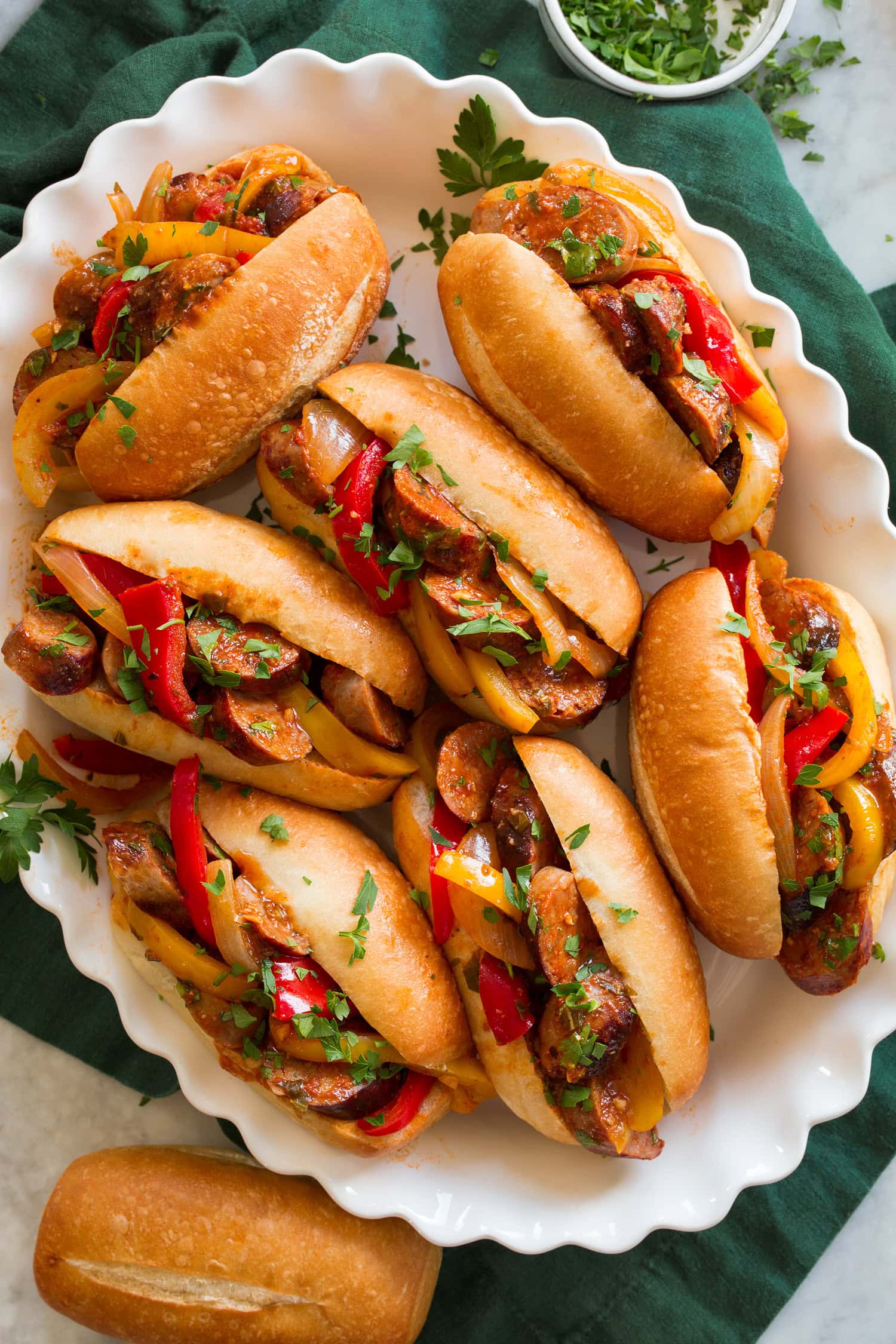 Italian Sausage and Peppers Sausage and peppers shown served in small hoagie buns.