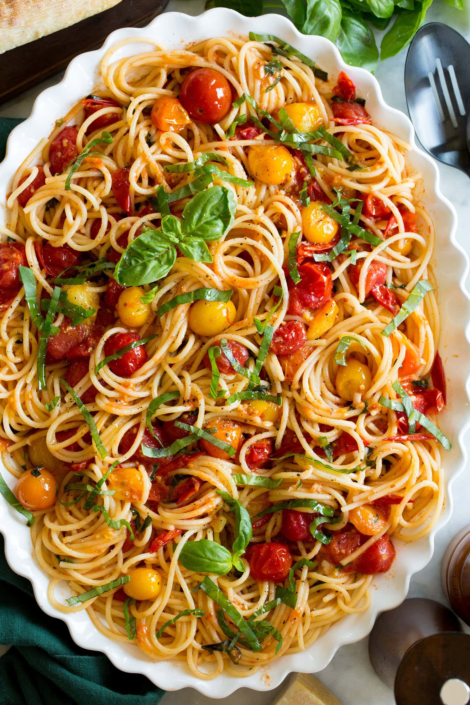 Cherry Tomato Pasta Close up photo of spaghetti with cherry tomato sauce and basil.