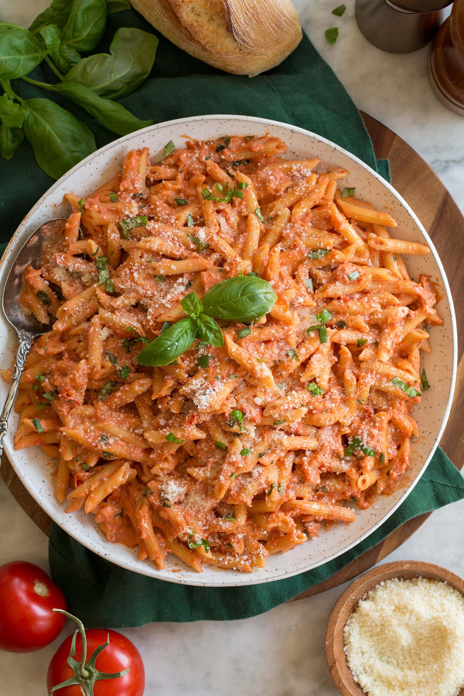 Creamy tomato pasta shown made with mini penne pasta and a homemade creamy tomato sauce with fresh basil.
