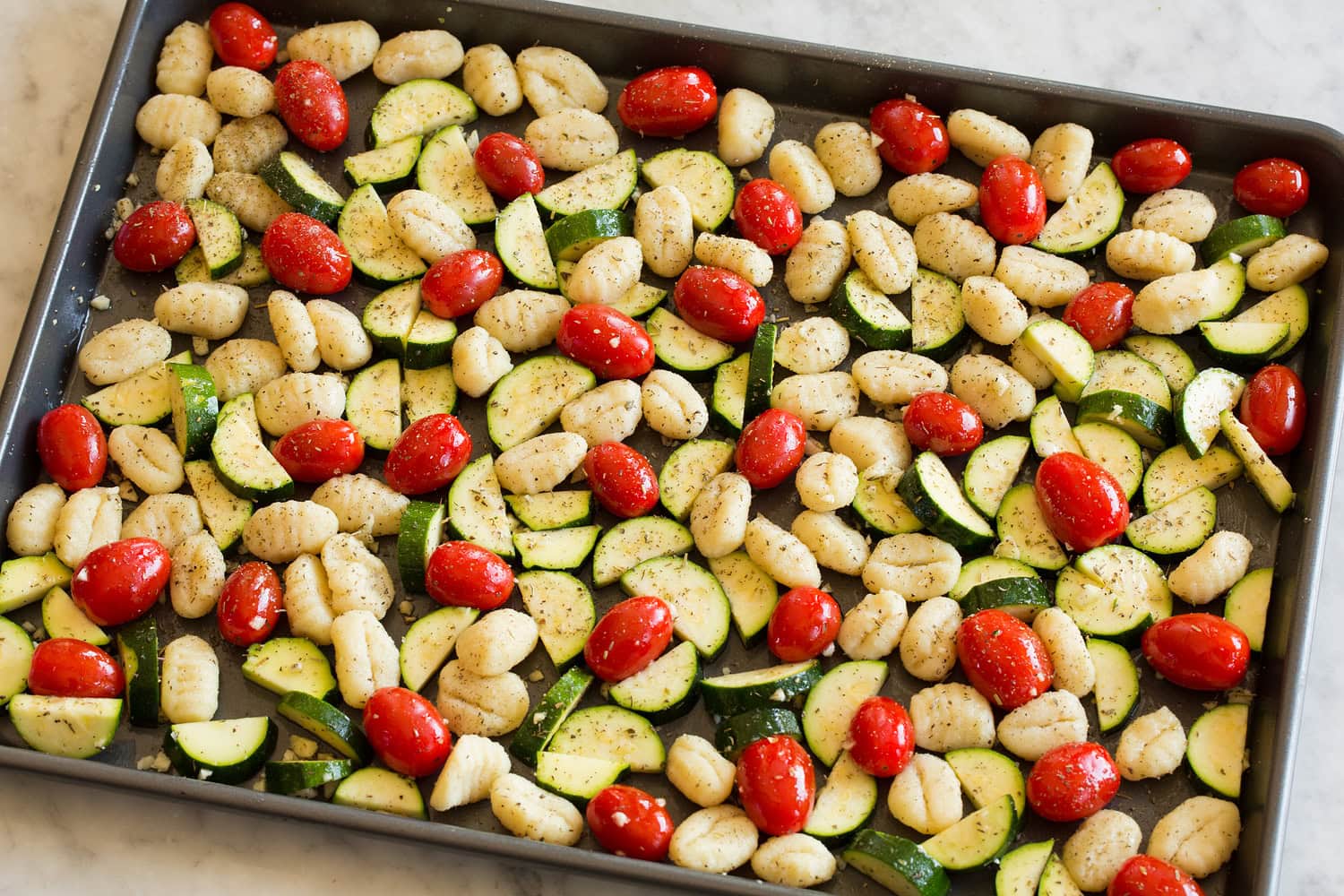 Sheet Pan Gnocchi with Zucchini and Tomatoes Tossed gnocchi mixture on baking sheet.