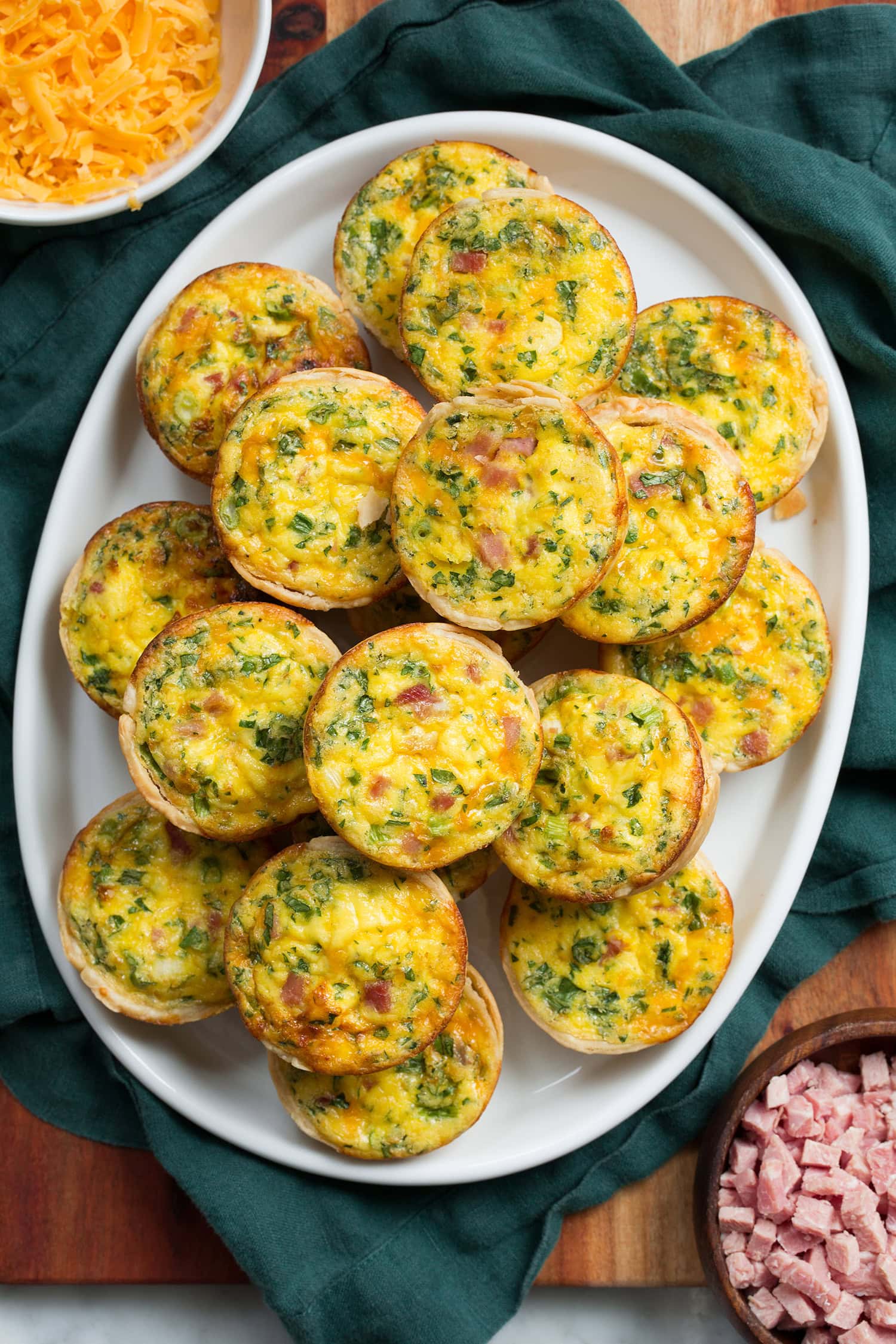 Mini Quiche Overhead photo of mini egg quiche with ham and herb fillings.