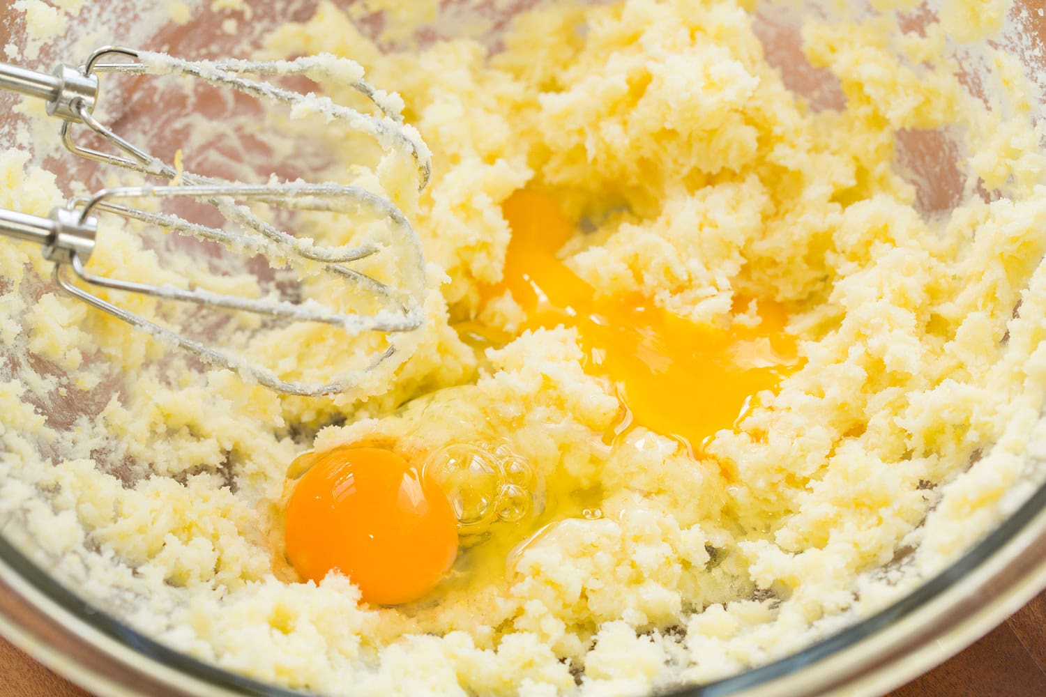 Lemon Cookies Creamed butter and sugar with eggs added in mixing bowl.