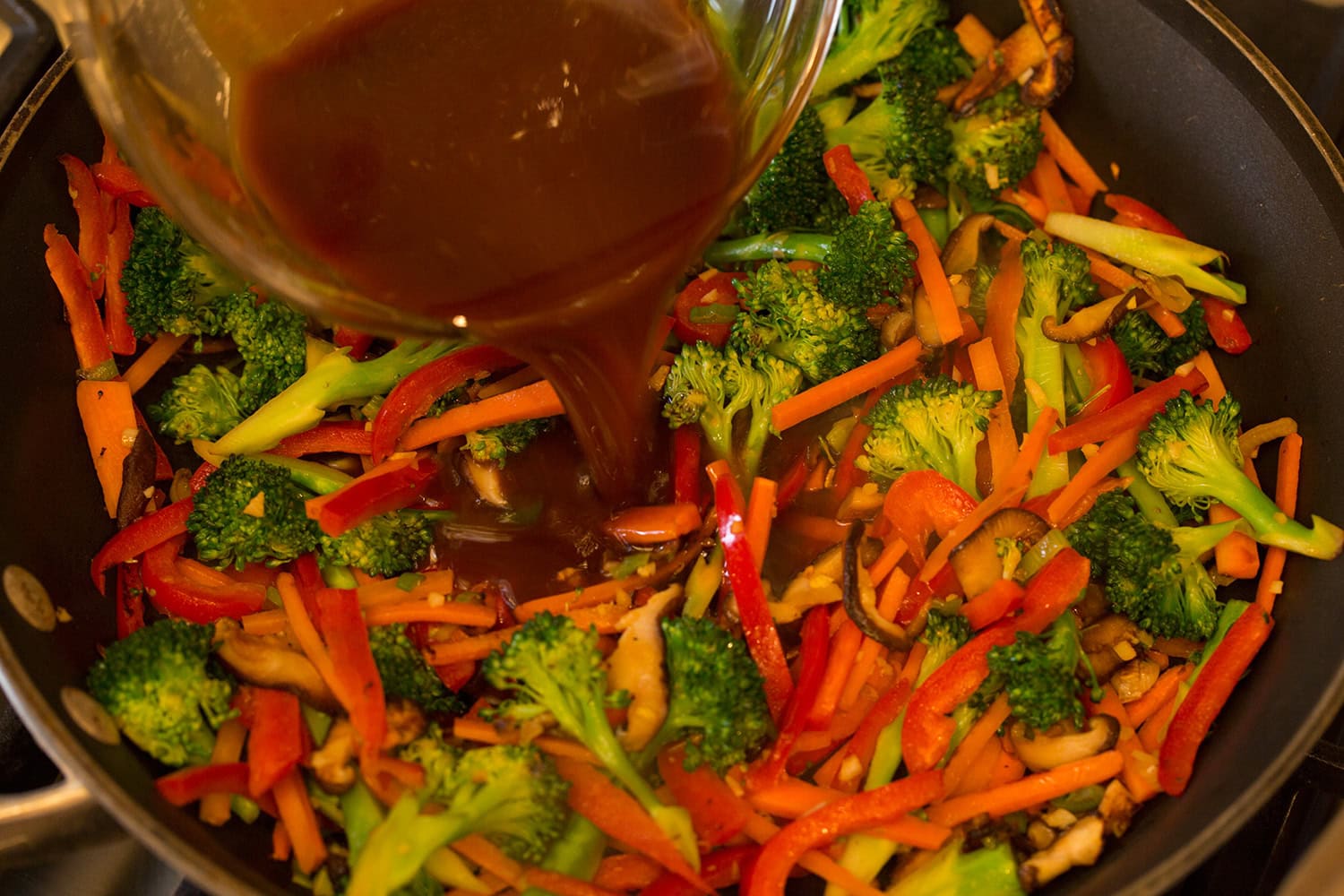 Stir fry sauce added to sauteed vegetables.