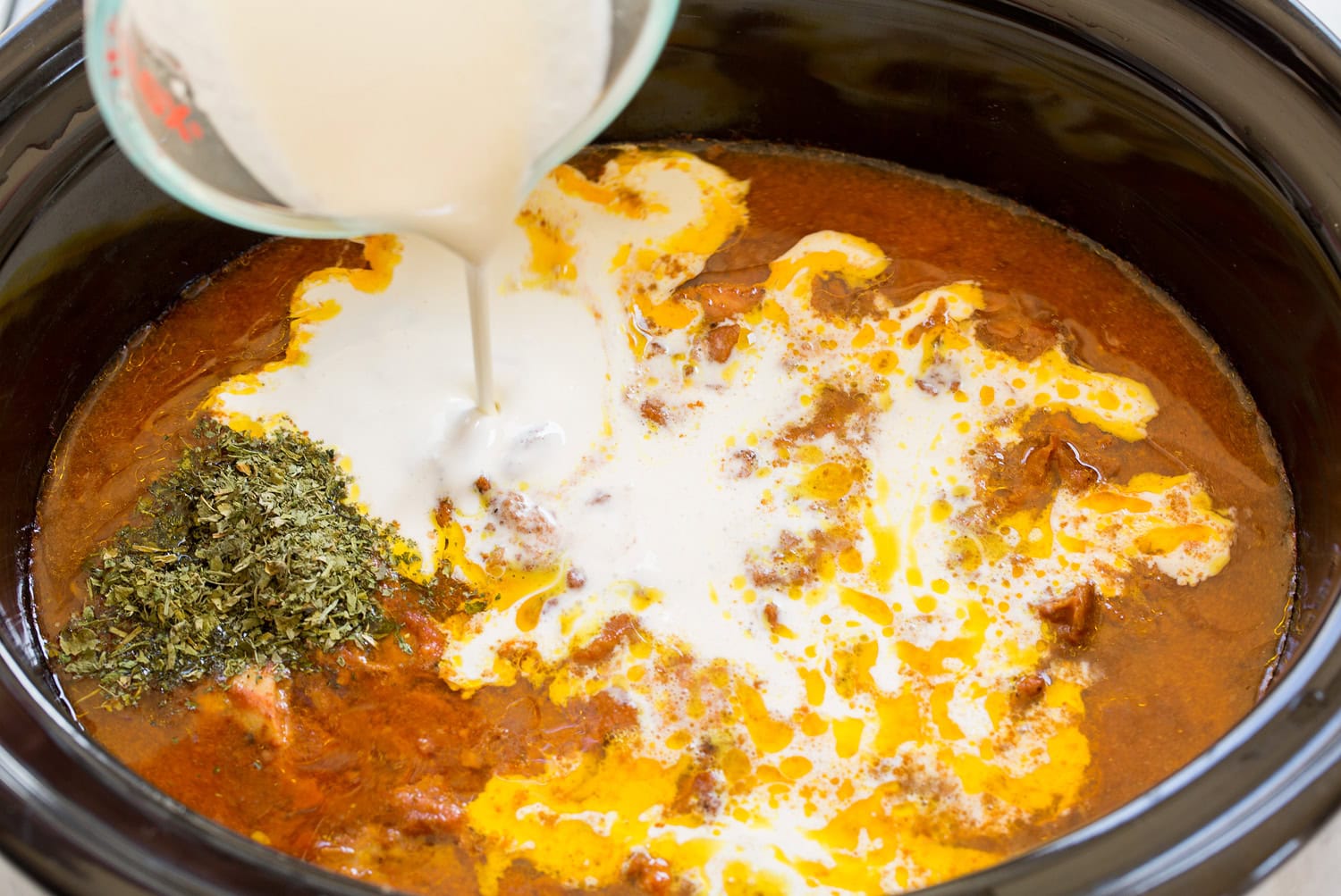 Slow Cooker Chicken Tikka Masala Cream and fenugreek added to cooked chicken tikka masala mixture in slow cooker.